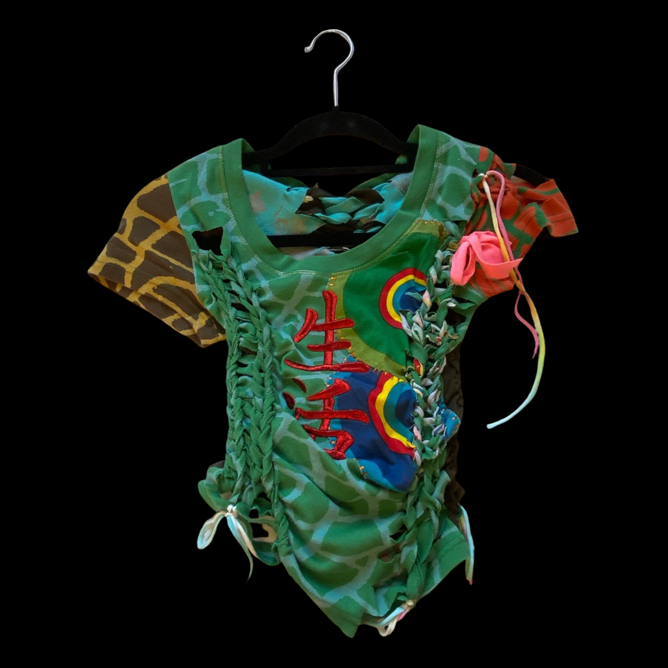 Colorful shirt with embroidery and ribbon ties on a black background.