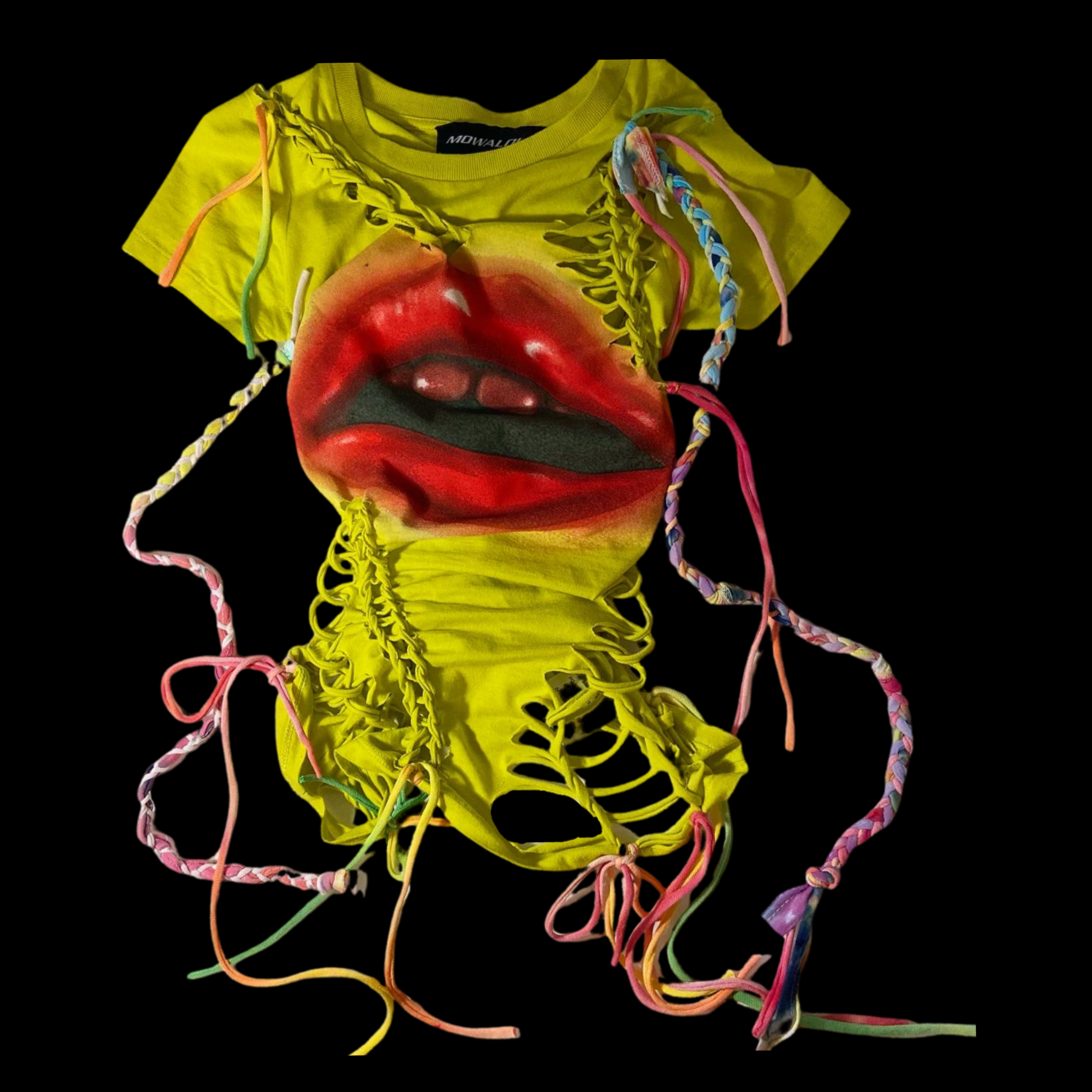A yellow T-shirt with a large graphic of red lips on the front, distorted with fabric lacing and multicolored braided strings on a black background.
