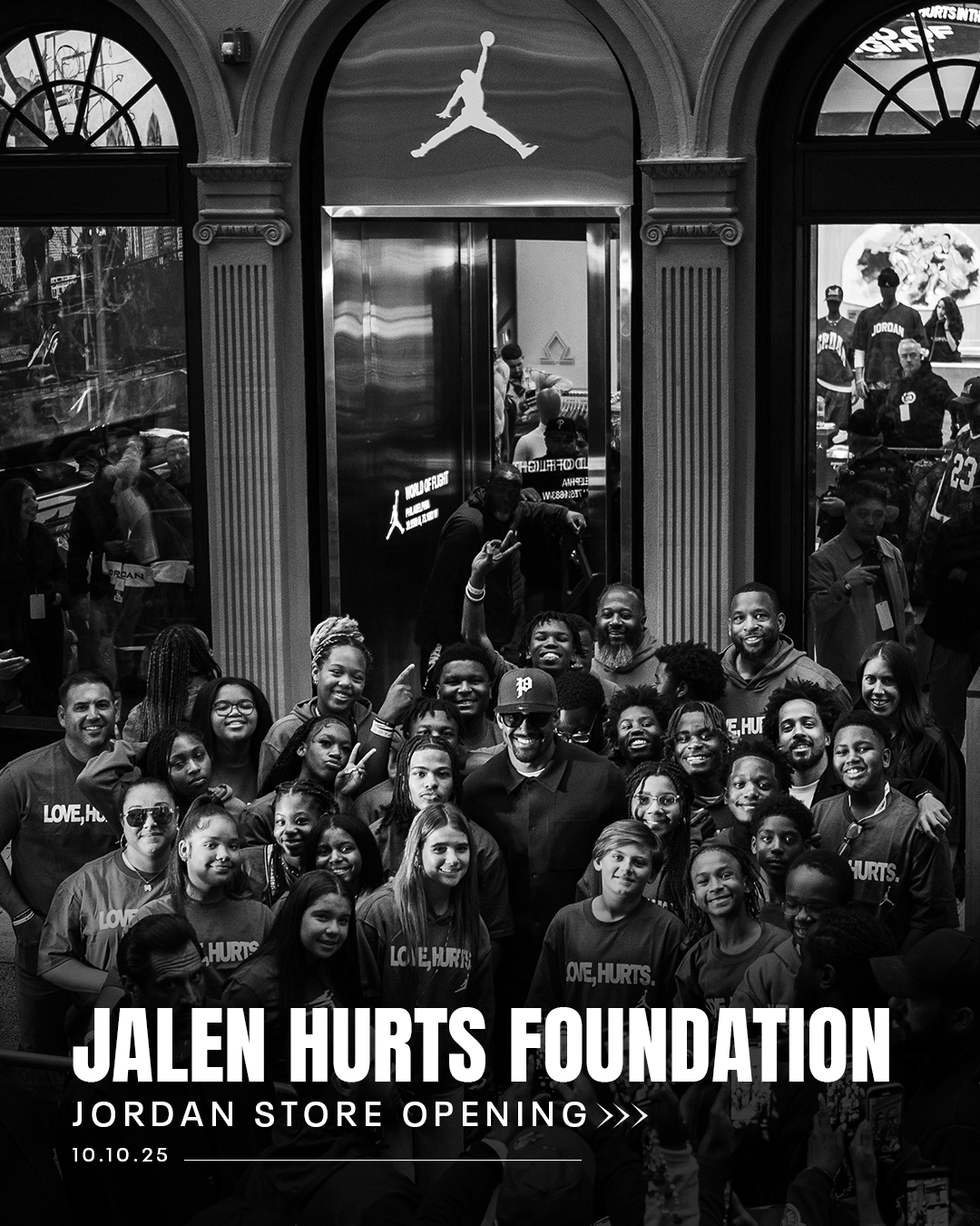 Fans crowd around Jalen Hurts some smiling and making peace signs, celebrating the Jordan store opening for Jalen Hurts Foundation on October 10, 2025.