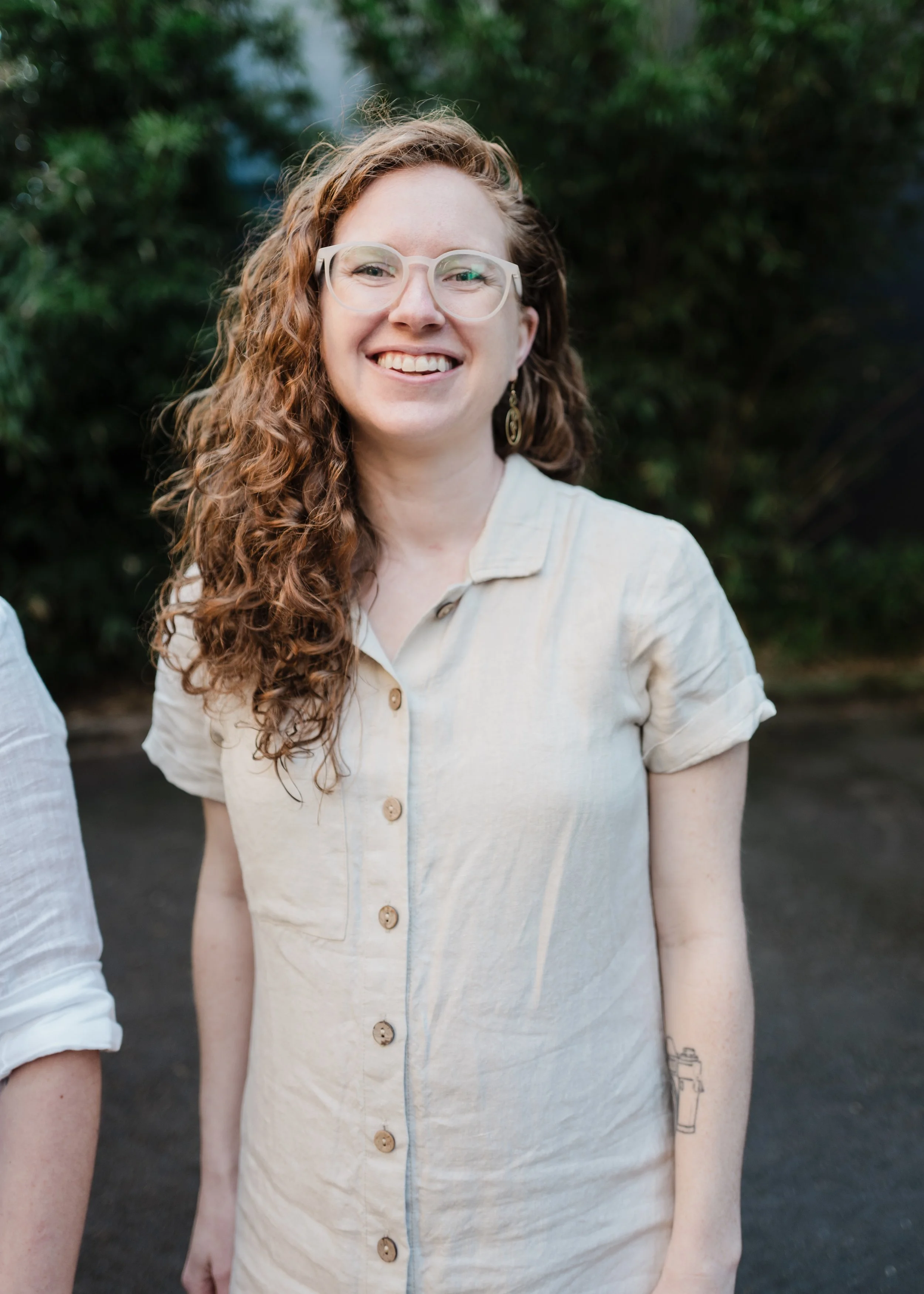 Portland wellness practitioner in glasses and off white top 