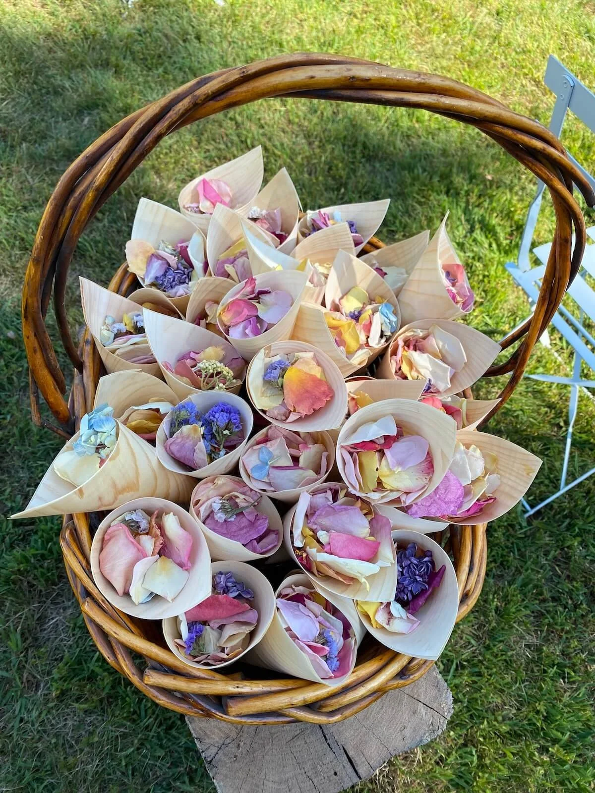 Paper thin wooden cones with flower petals to throw at bride and groom