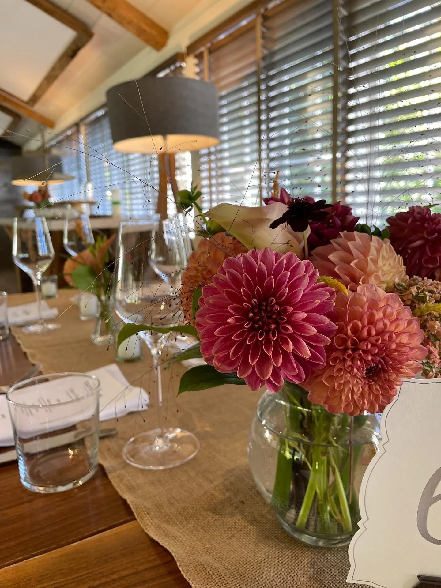 Seasonality drove our flower selection for this recent September wedding reception. The client&rsquo;s only request; a rich Fall color palette of burgundy, apricot, and raspberry. These mixed dahlias, chocolate cosmos, celosia, and explosion grass re
