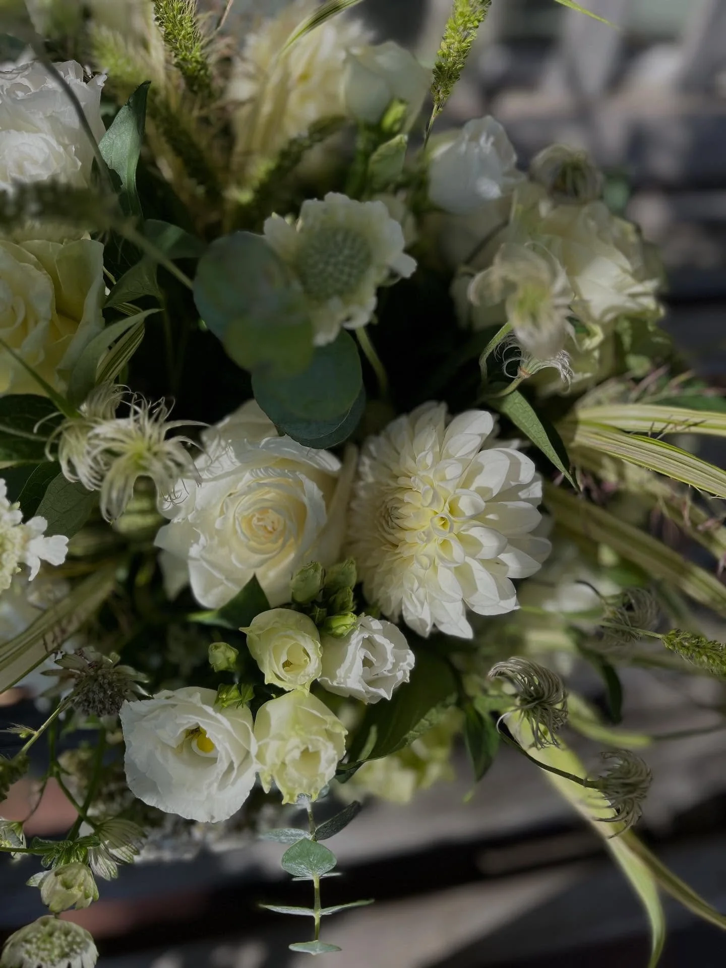 Beachy inspired floral arrangement, while keeping it Fall. Client requested something beachy with grasses. We selected white dahlias, yarrow, roses, scabiosa, and lisi with astrantia, clematis pods, and native grasses. 

#floraldesign #floralcenterpi