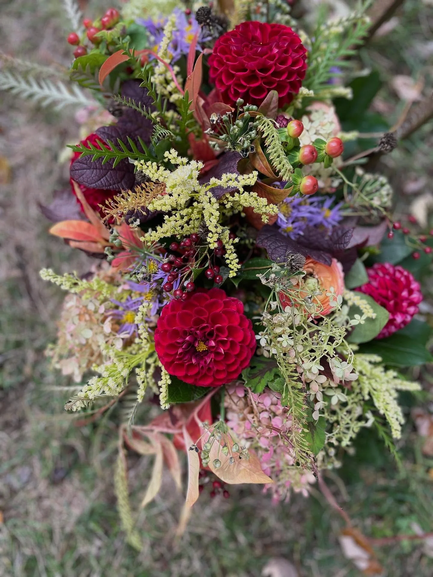 Eating up all the seasonal textures with this recent table centerpiece order. 

Red dahlias, goldenrod, purple asters, and pee gee hydrangea with seasonal berries &amp; foliage. 

#falldesign #fallfloral #floraldesign #centerpiece