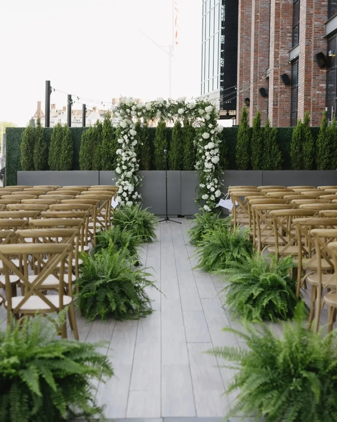 We create a lush ceremony space for Randi &amp; Charles&rsquo;s wedding with an aisle of Boston ferns and a full floral arch for the perfect backdrop.

The ferns were repurposed and joined the party upstairs for the reception 🥂 This space was kept m