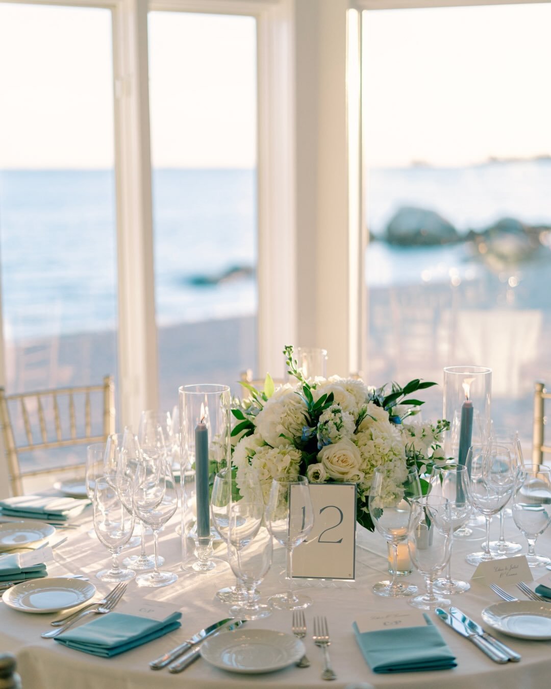 Reliving this fairytale blue and white reception at the Wee Burn Beach Club in Norwalk, Connecticut. 

This color palette is timeless and elegant. We designed with white dahlias, hydrangea, lisianthus, roses, and stock; adding moments of blue with de