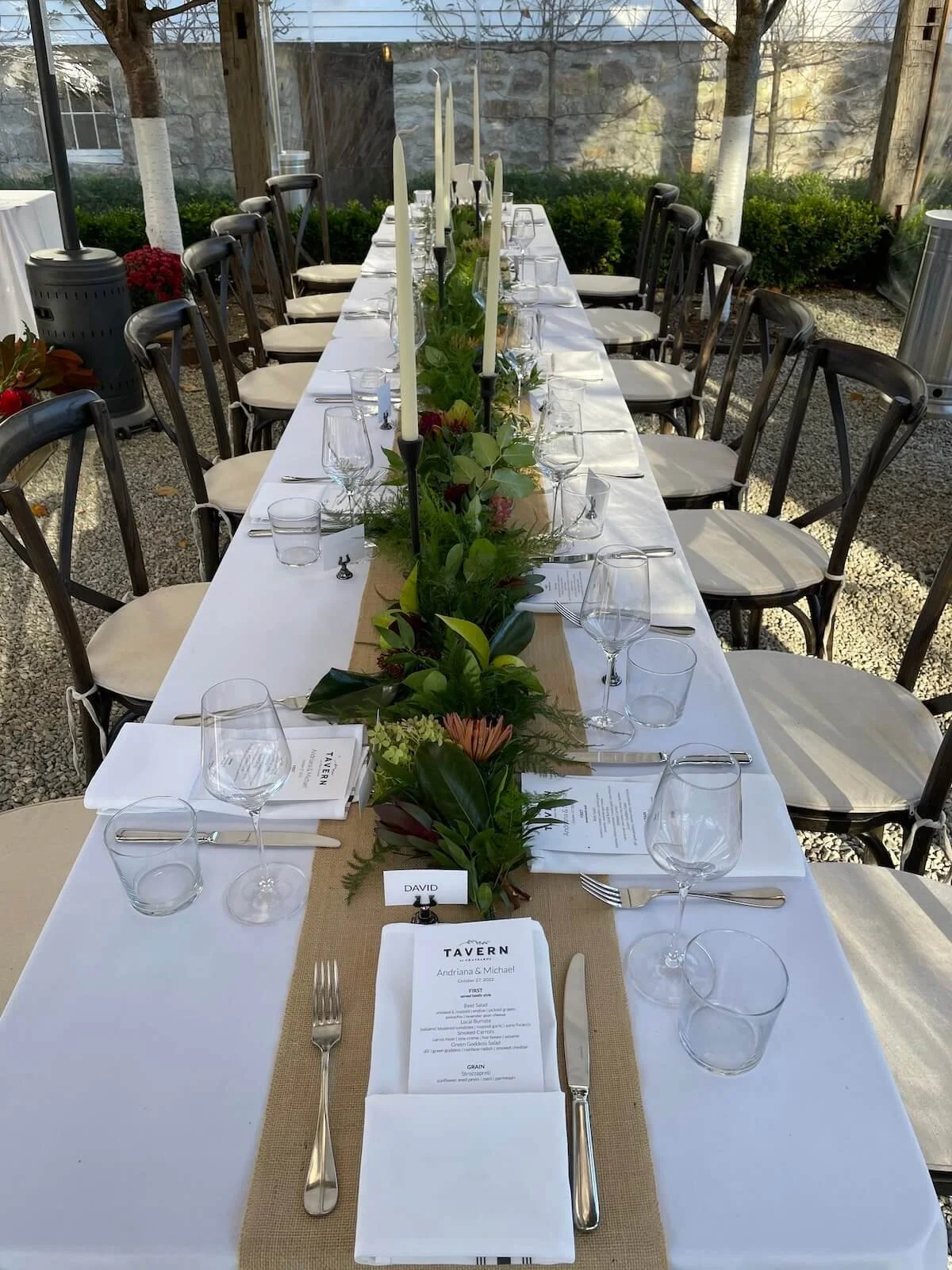 Long wedding talbe set with greenery with black and white florals.jpeg