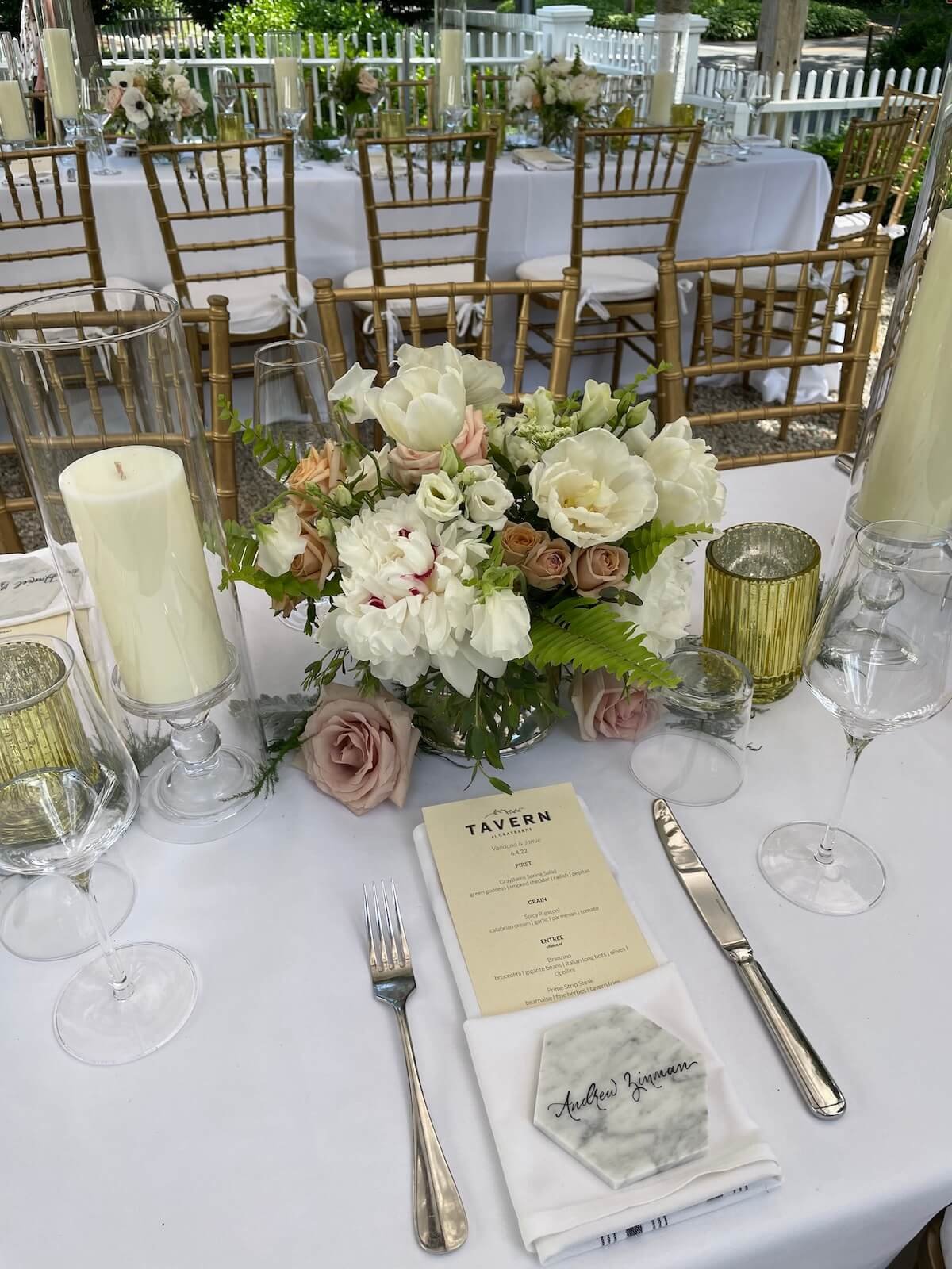 Wedding tablesetting with white mauve and green floral arrangment.jpeg