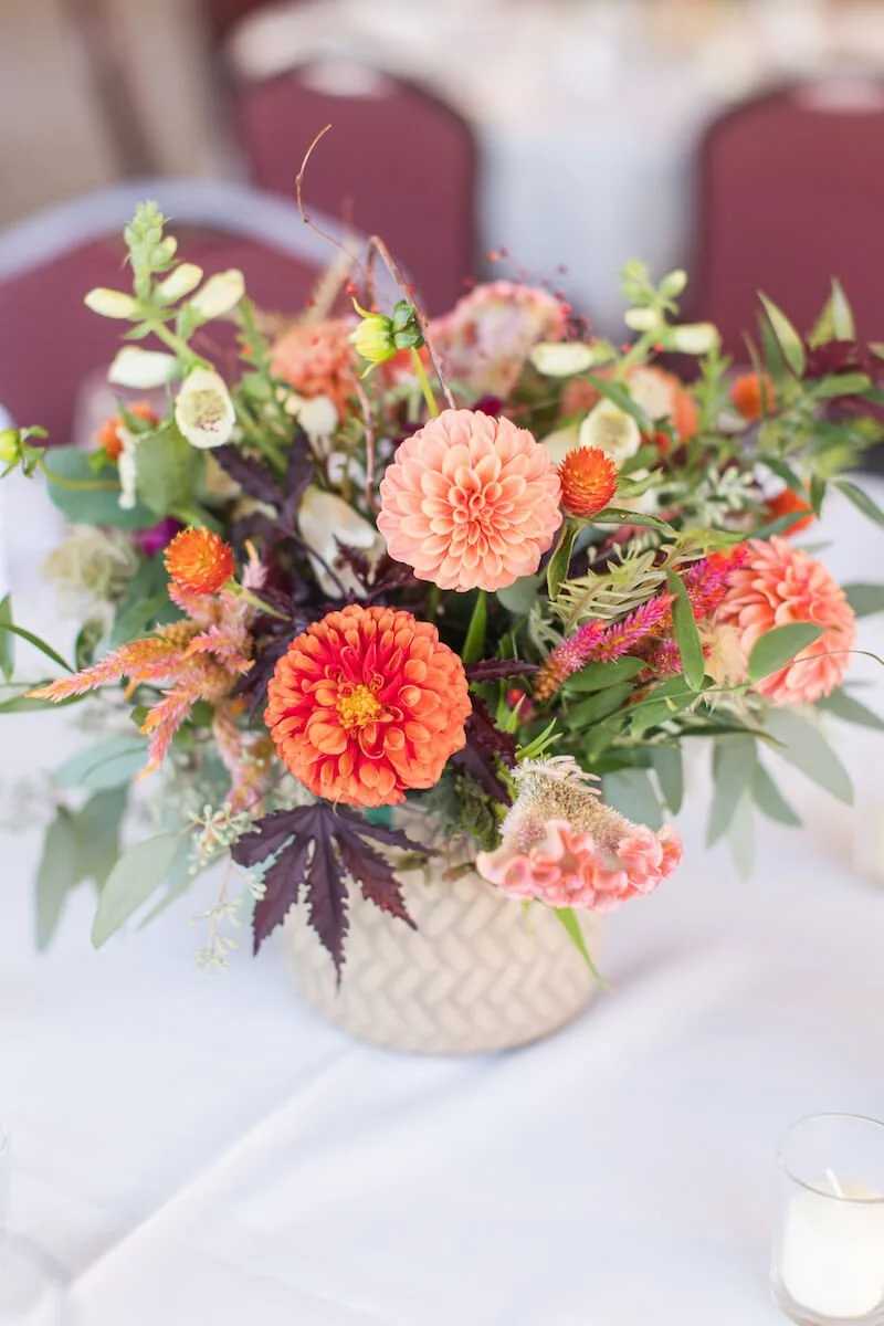 Close up of Orange floral arrangment at a table.jpg