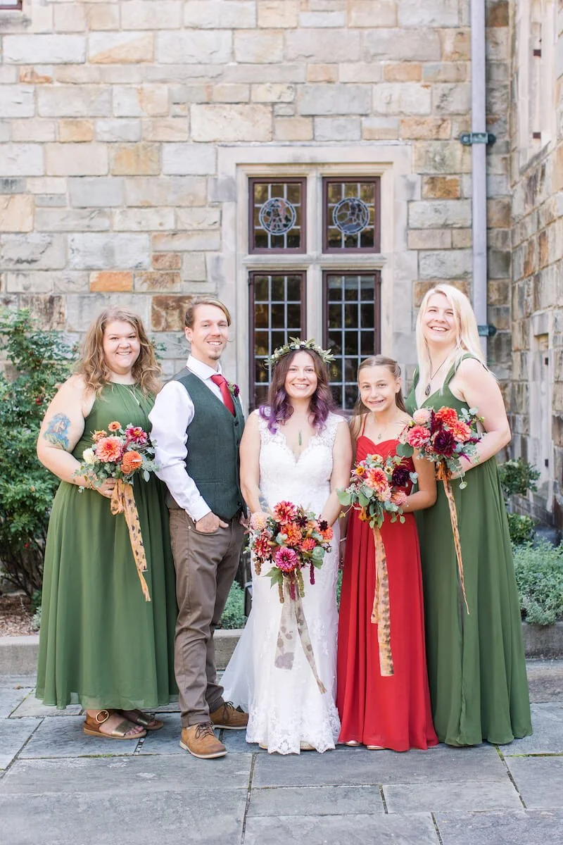 Wedding party in reds and greens holding flowers.jpg