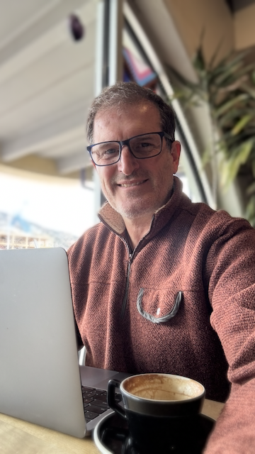 Stan Ajemian, life coach at Being the Change Coaching, with his laptop and coffee.