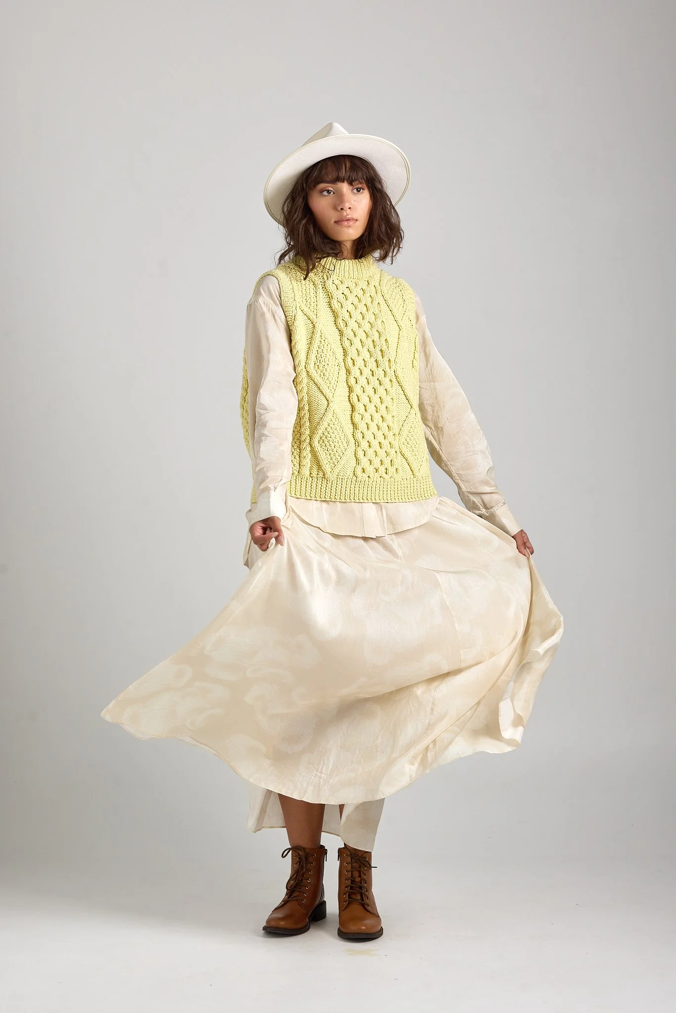 Minimal studio fashion image with a soft beauty approach, featuring First Born Knit