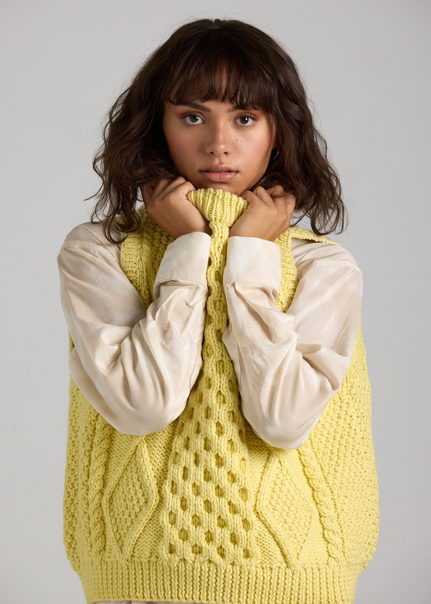 Fashion-focused studio portrait showcasing First Born Knit textures and styling