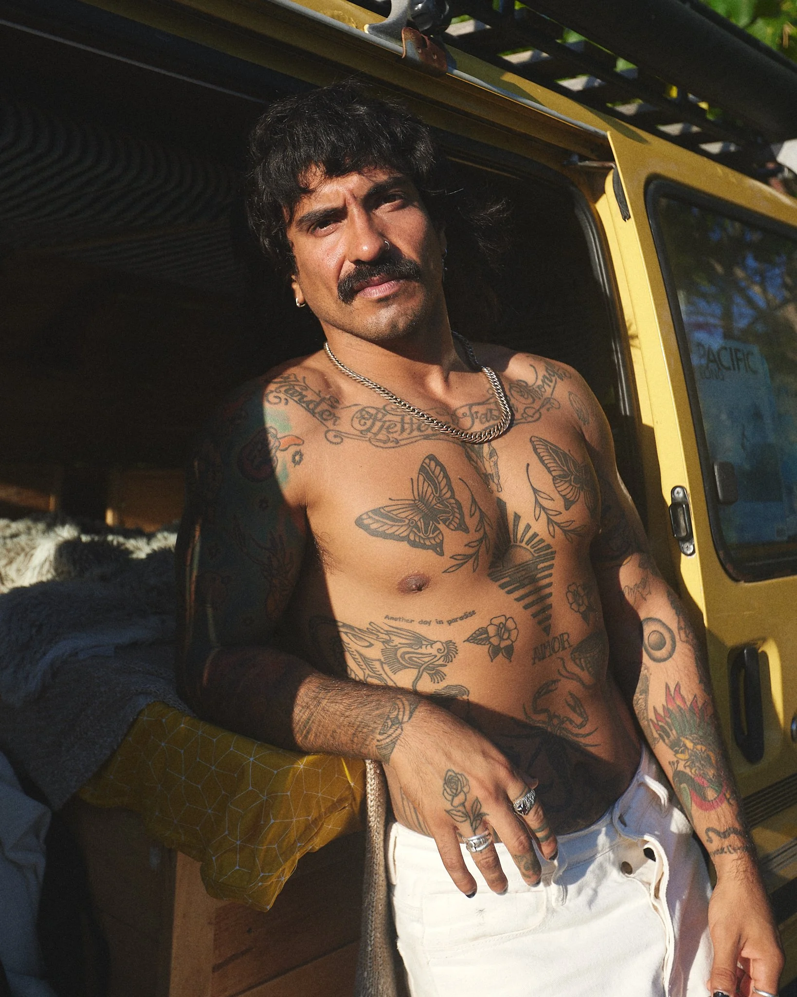 Lifestyle fashion portrait with a hippie gypsy vibe beside a van.