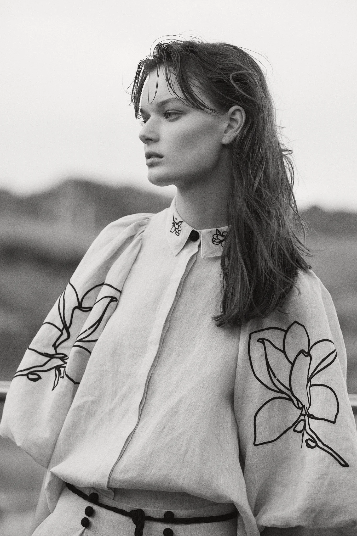 Strong editorial portrait of a high-fashion model with confident expression.