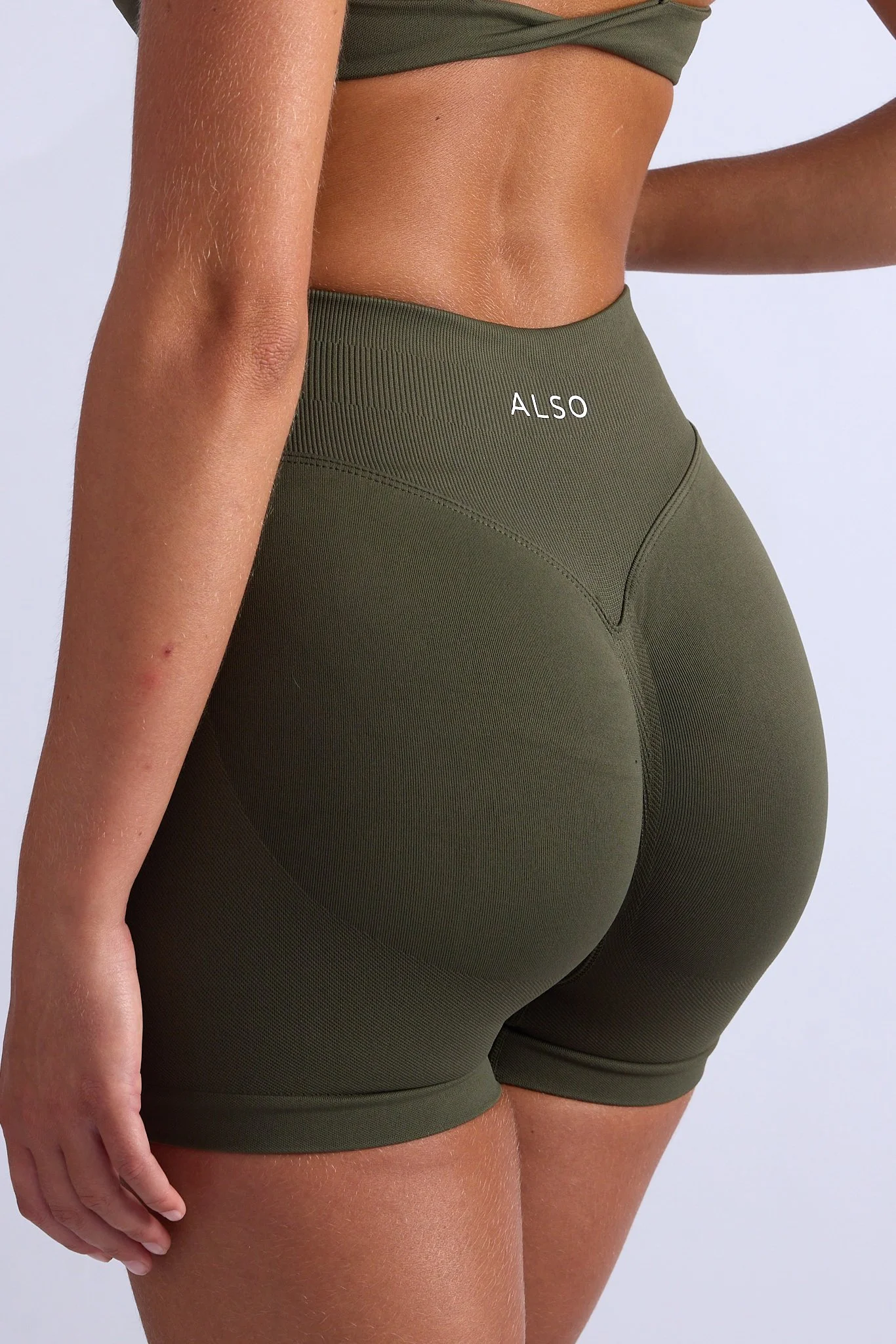 fitness apparel studio shoot for ALSO activewear, strong female model in dynamic pose, clean editorial style Gold Coast