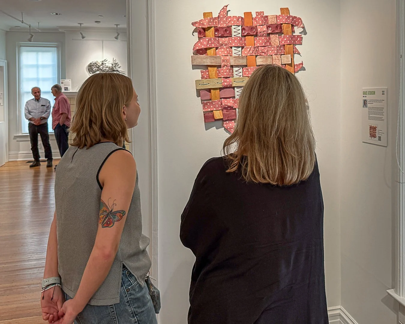 Artist Gracie Atchison and Juror Jeanne Chvosta view "Ceramic Weaving."