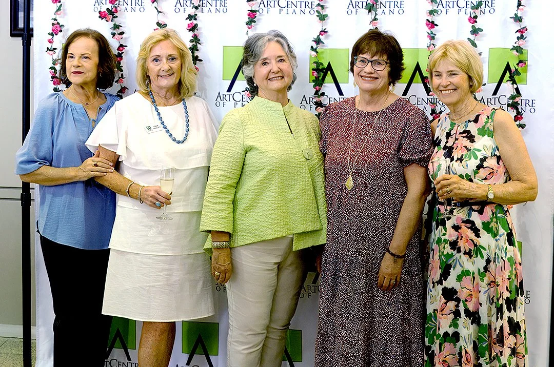 Five women posing in front of an Art Centre of Plano backdrop.