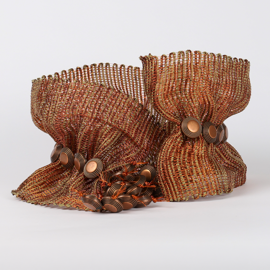 Decorative metallic mesh flower with copper and bronze buttons.