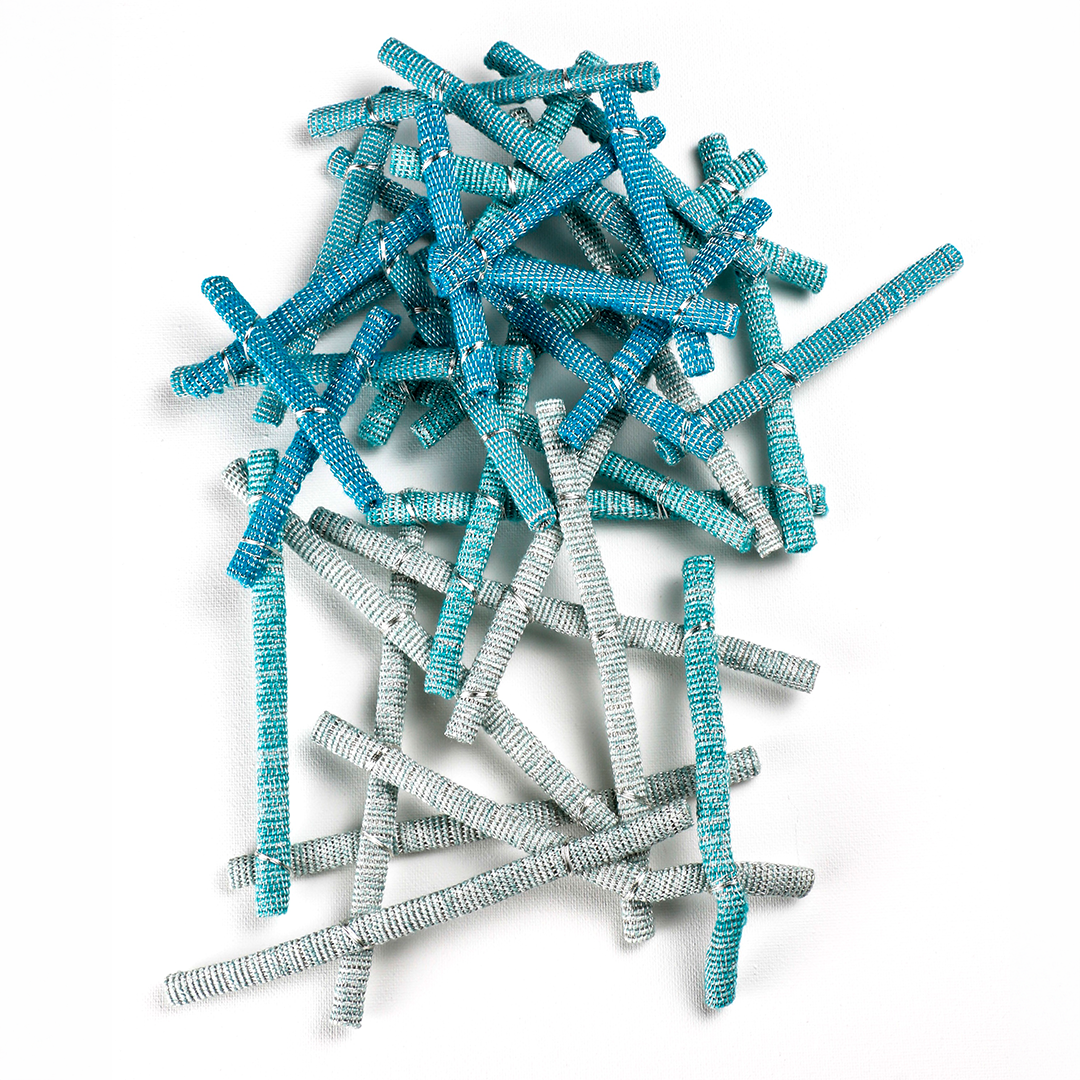 A pile of blue and gray crinkle-cut hair ties on a white background.