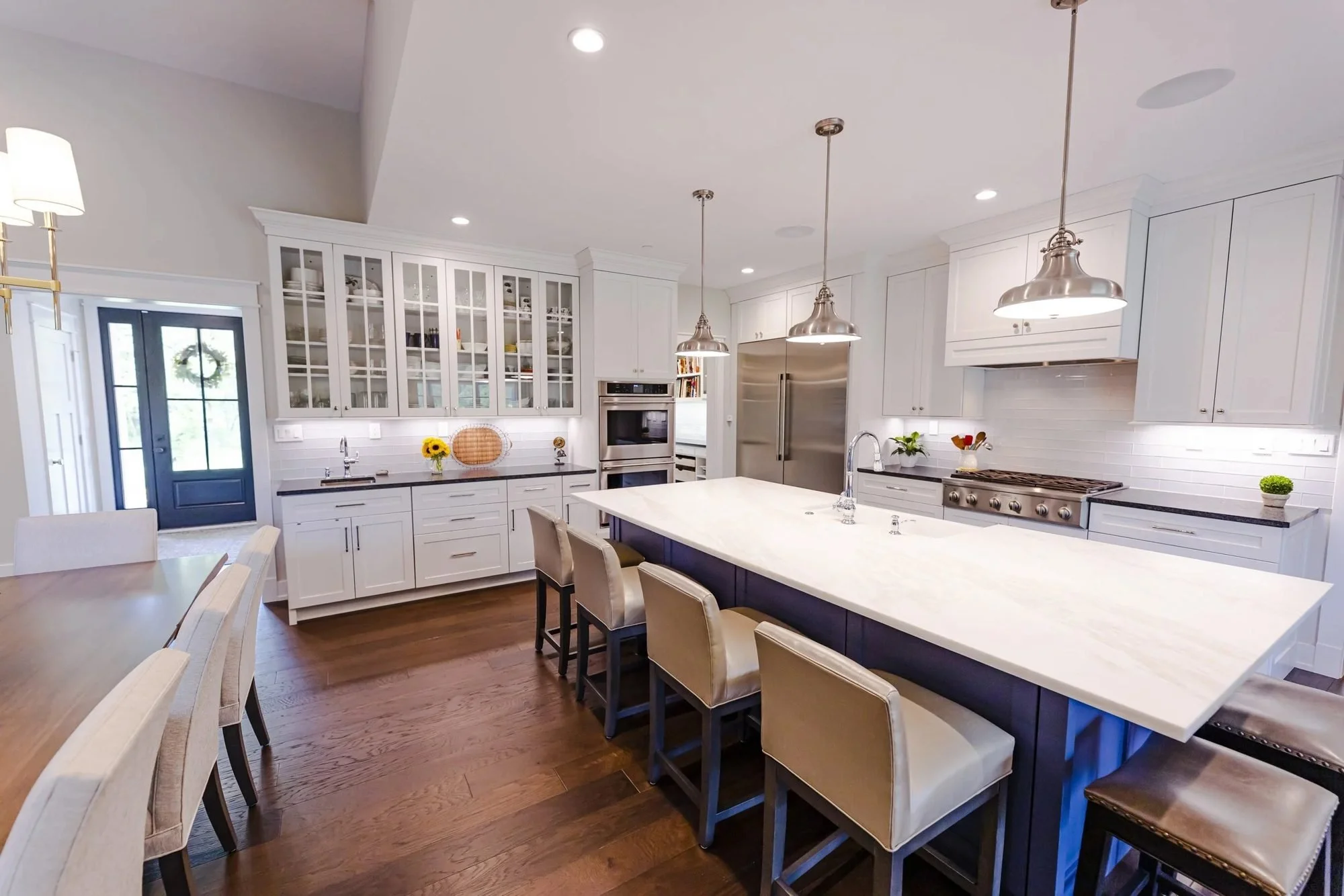 Custom kitchen with navy island and white cabinetry in a Doylestown home