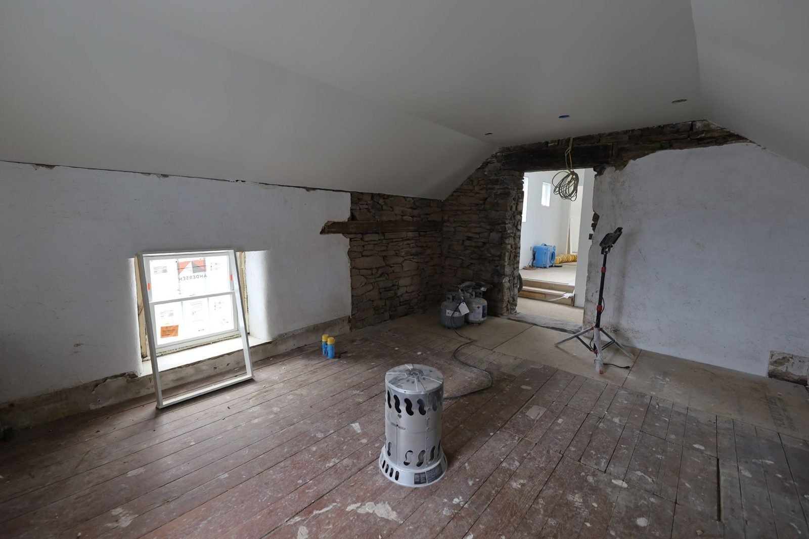 Original stone wall exposed in a finished attic in a Bucks County cottage