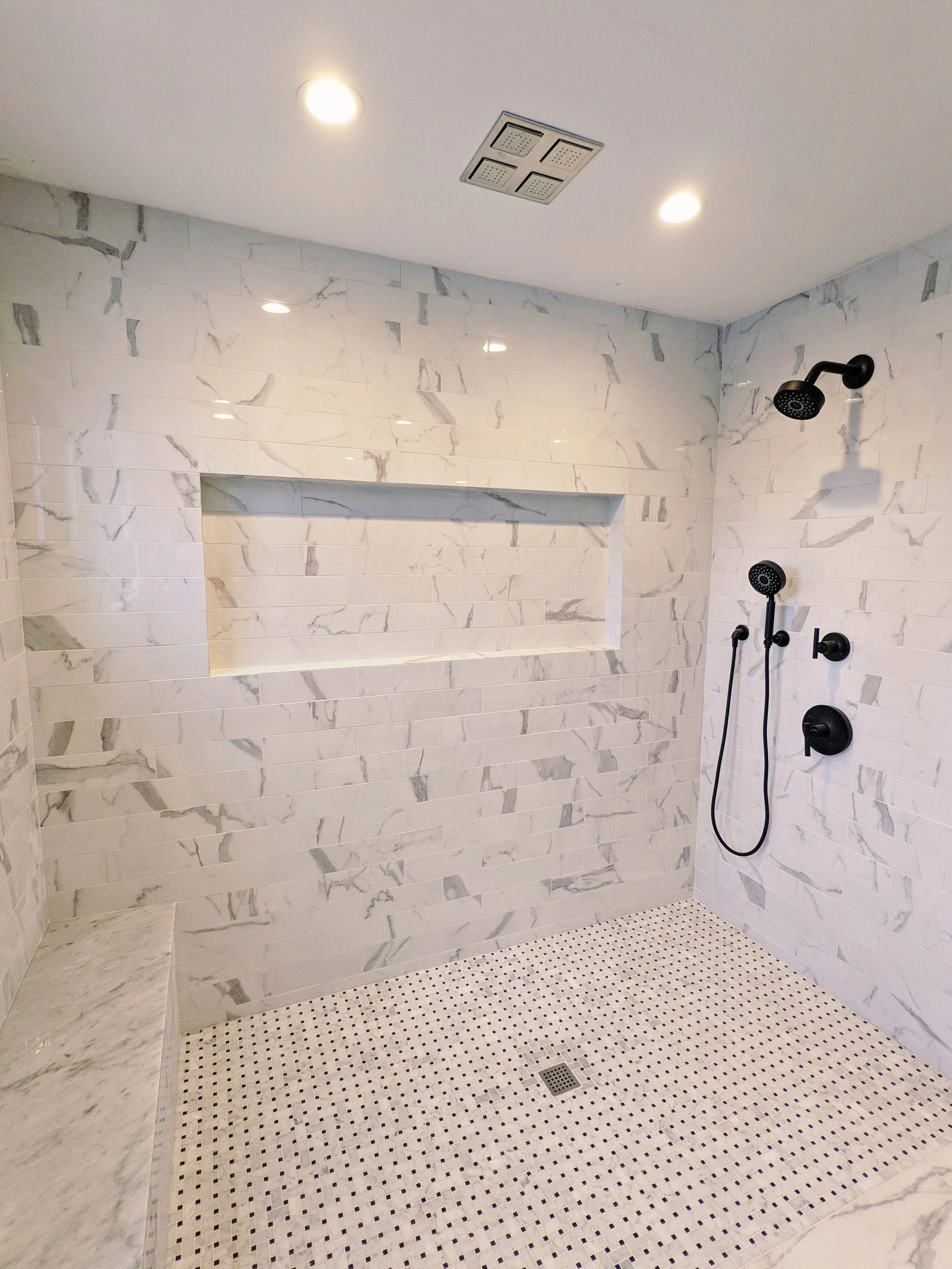 luxury-bathroom-walk-in-shower-blue-subway-tile.webp