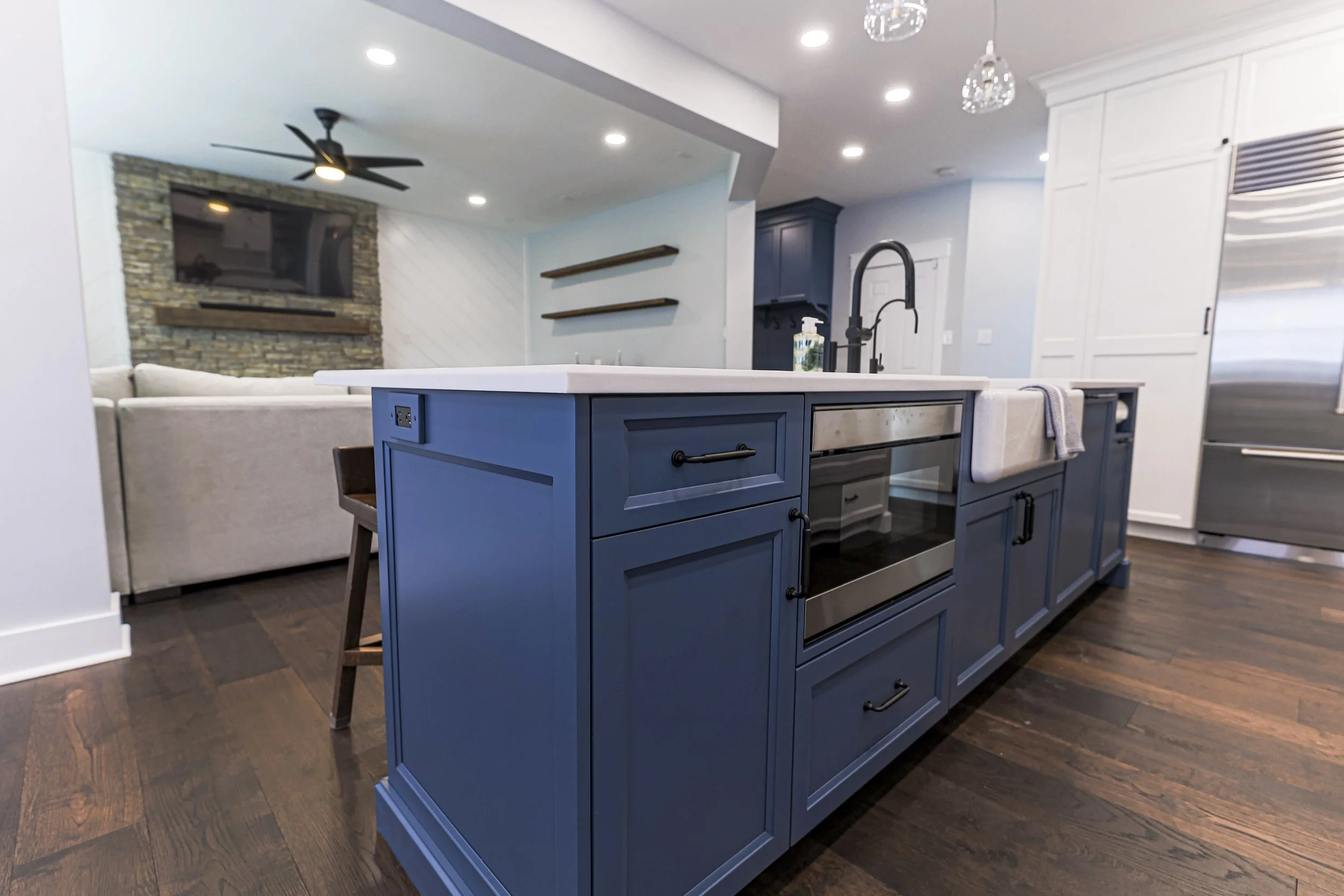 Navy island with microwave drawer looking toward the family room fireplace