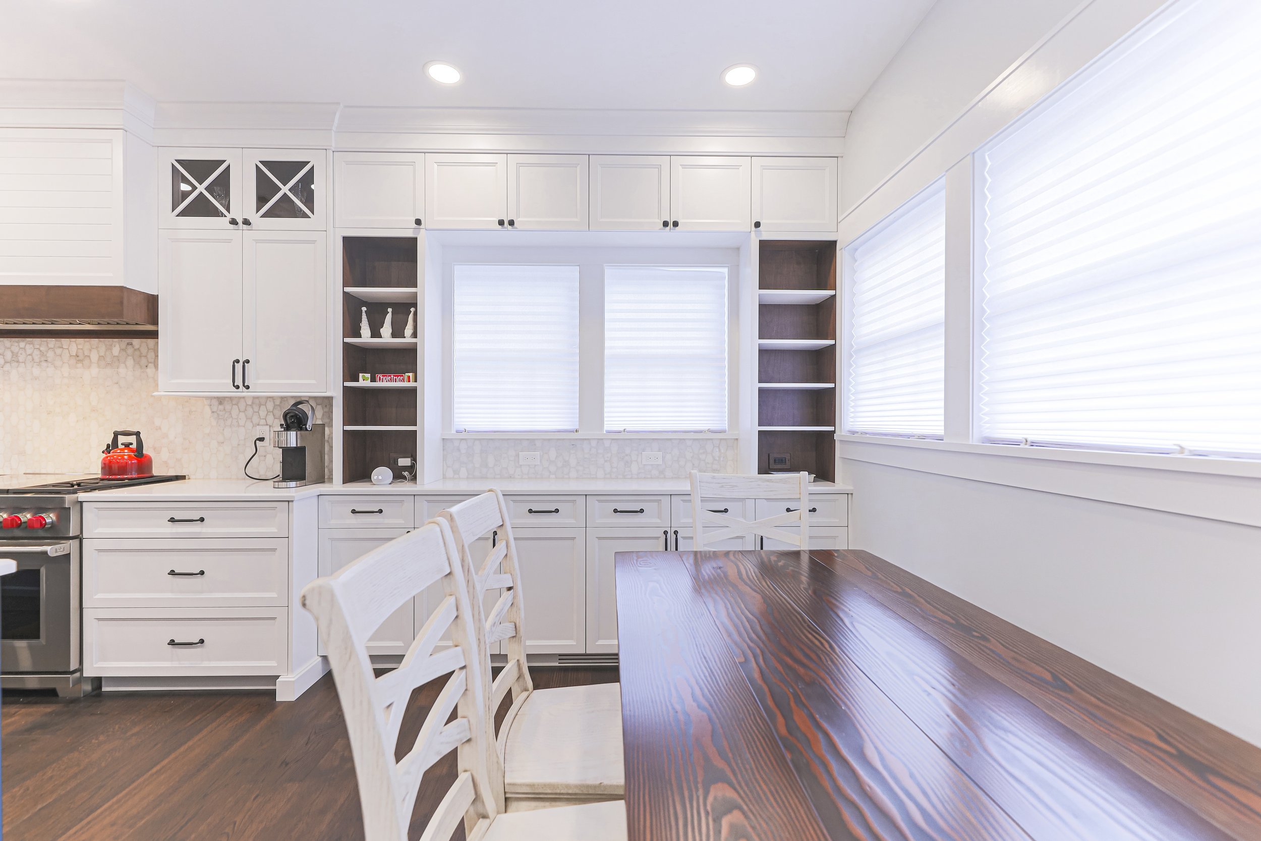 Breakfast area with built-in cabinetry, open shelving and large windows