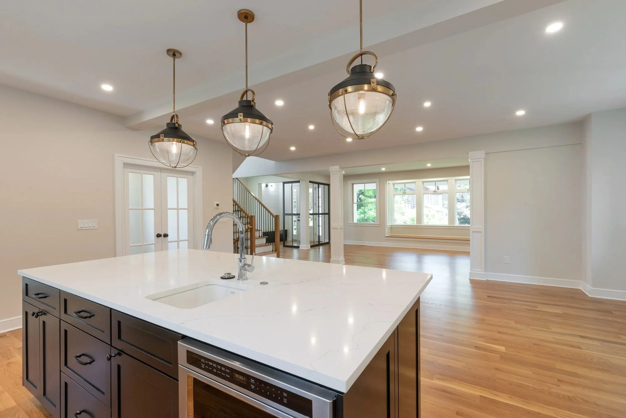 Kitchen island open to the living room and staircase