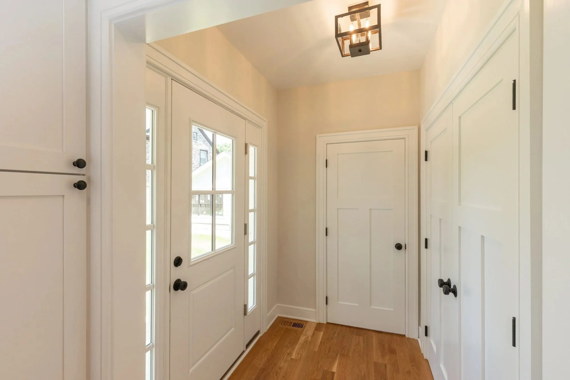 Side entry with glass-panel door, closet and lantern light