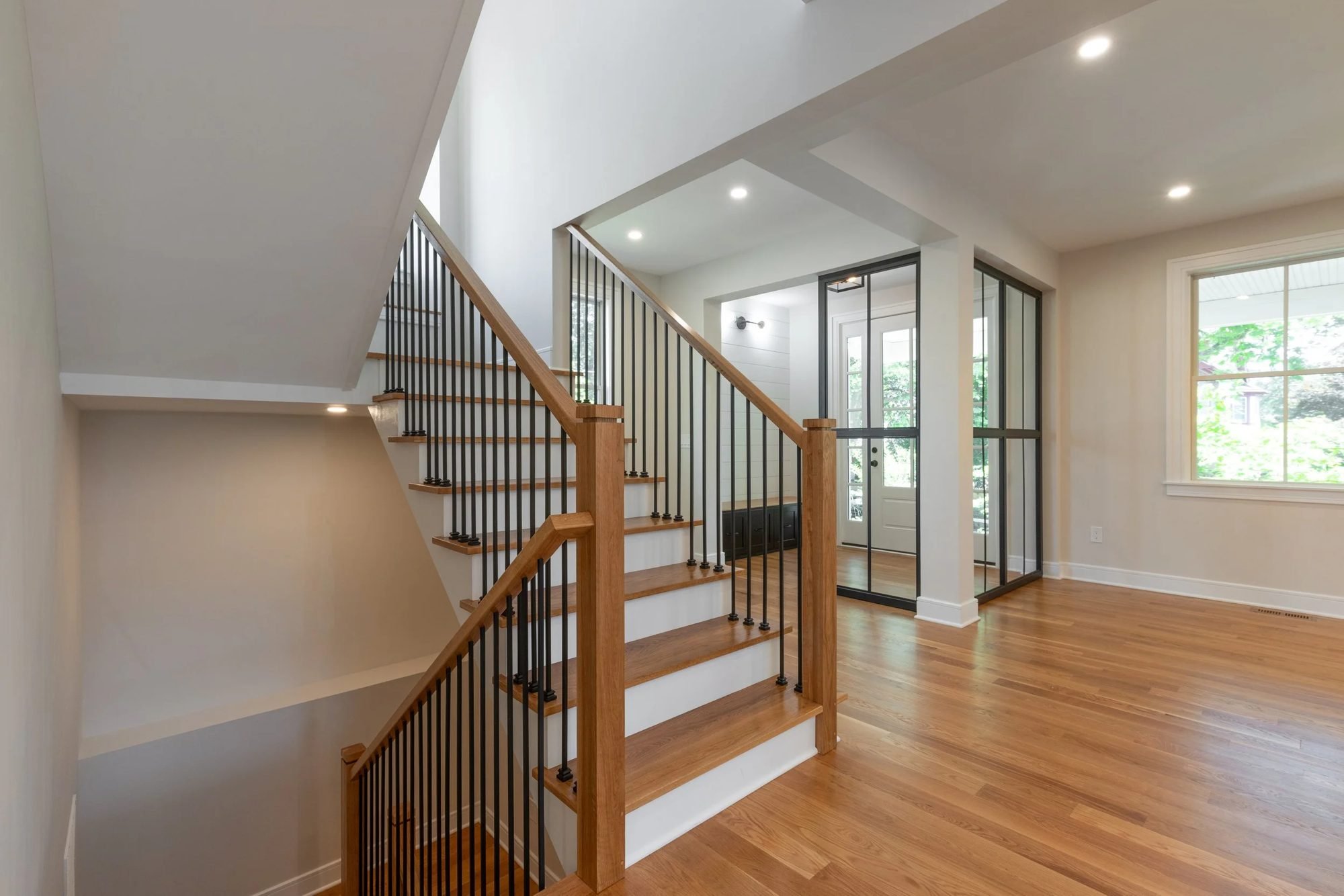 Open staircase with oak treads and black iron balusters