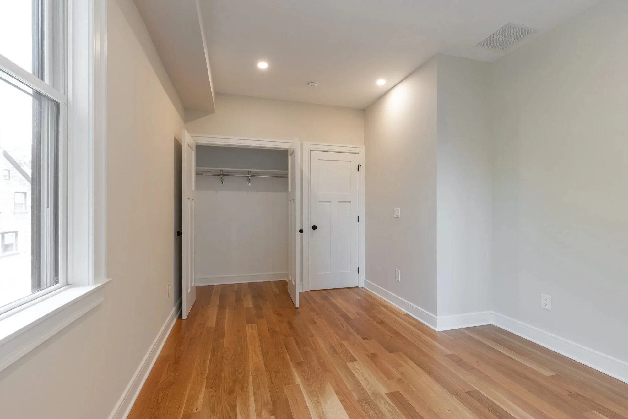 Bedroom with closet and hardwood floors