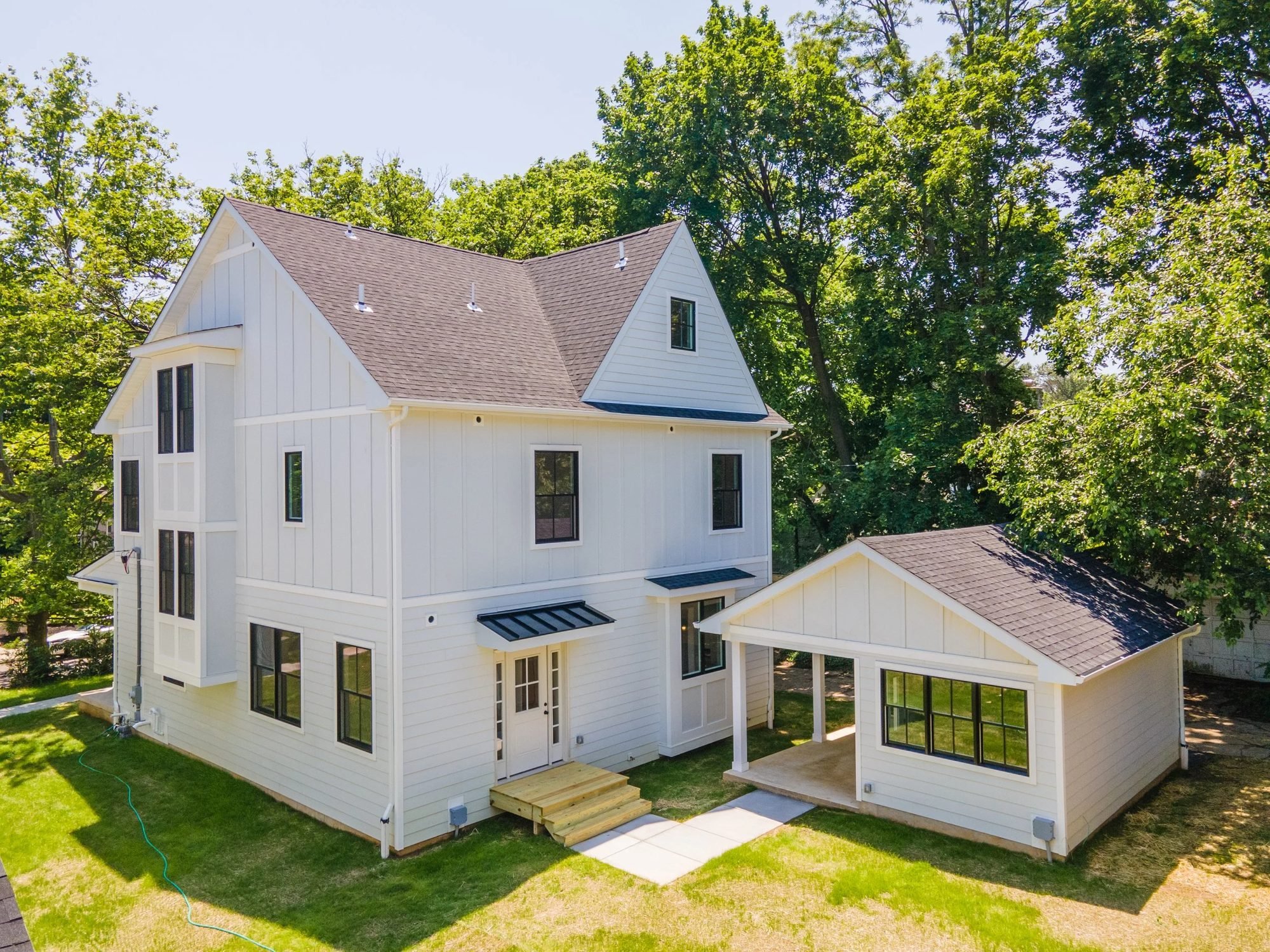 New construction home and detached garage seen from above
