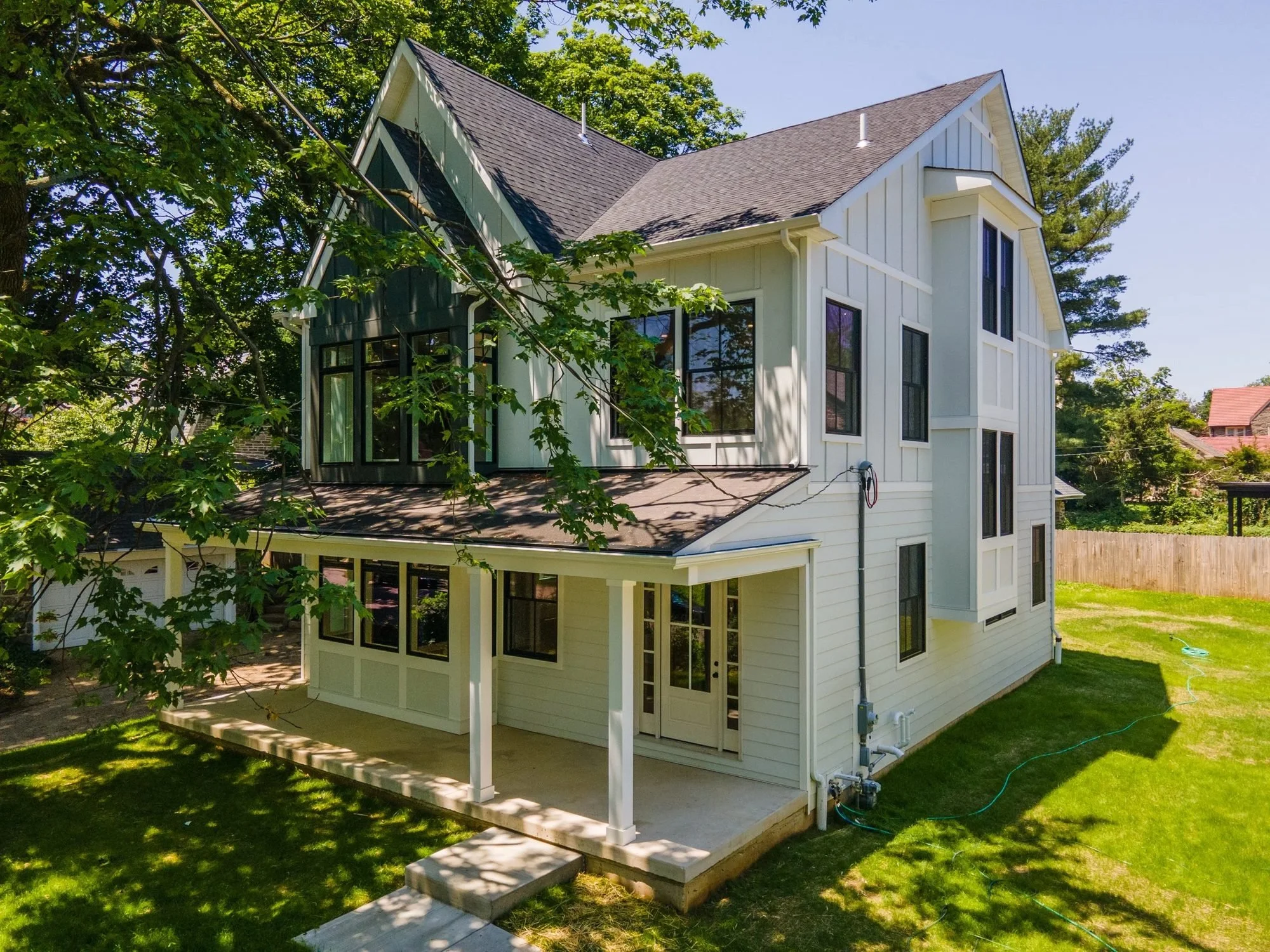 Board-and-batten home with covered porch from above