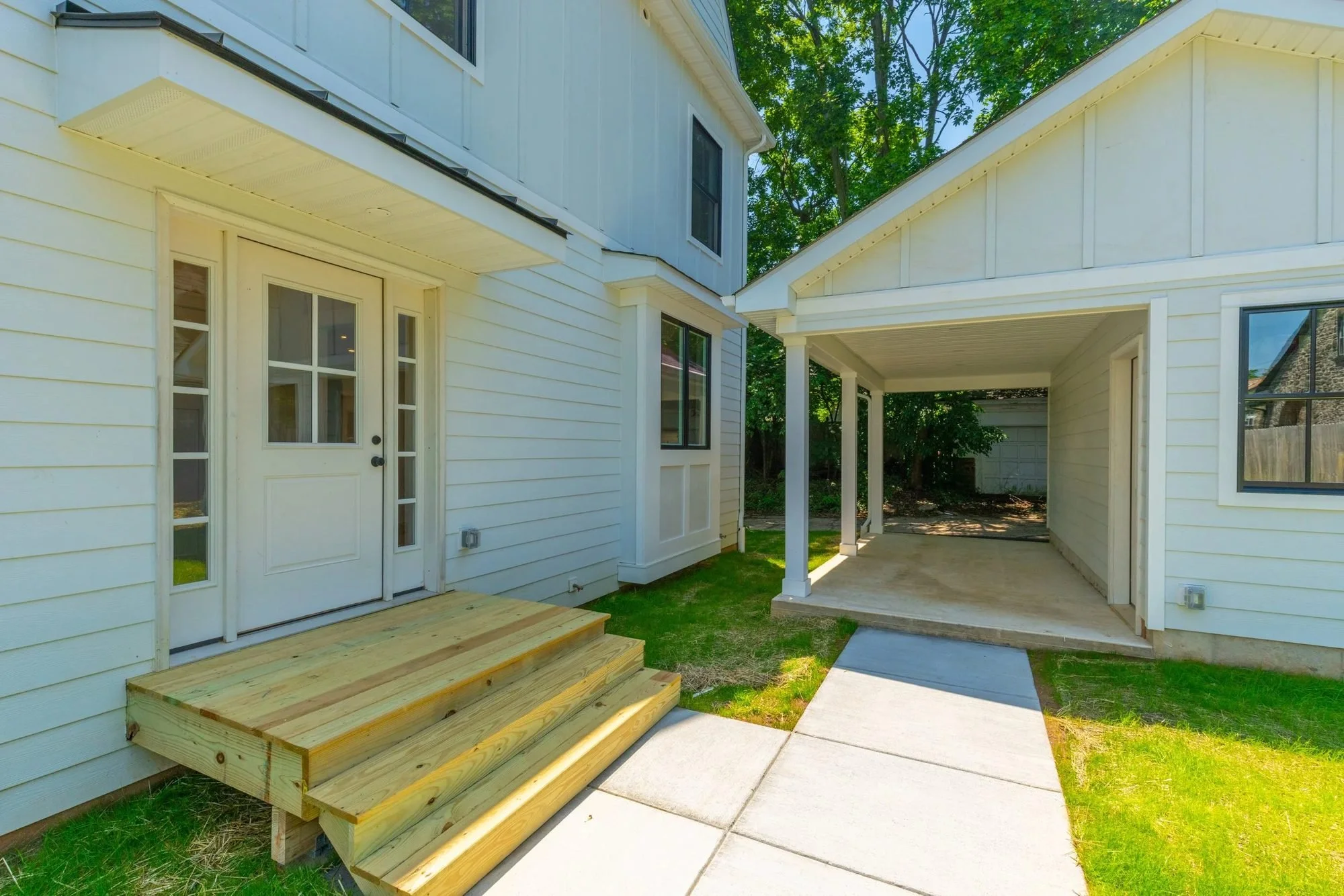 Side entry with new wood steps and covered breezeway