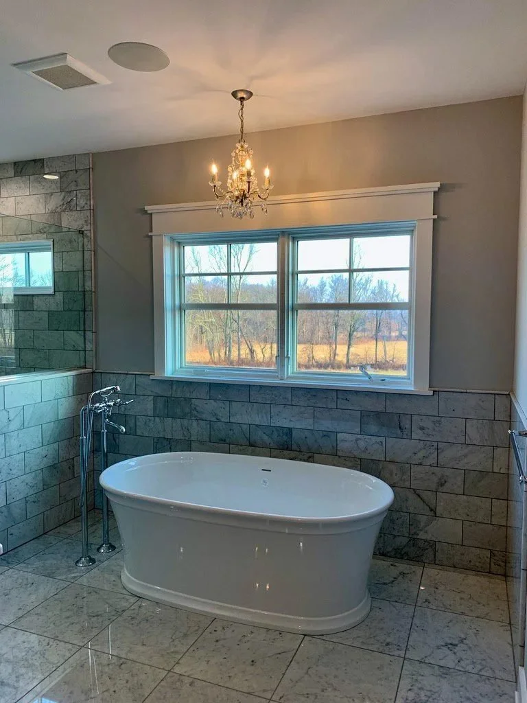 Doylestown bathroom renovation with a freestanding tub under a crystal chandelier