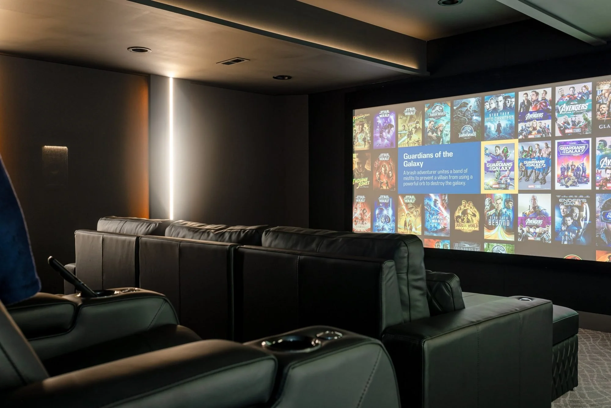 Basement home theater with leather recliners and projector screen