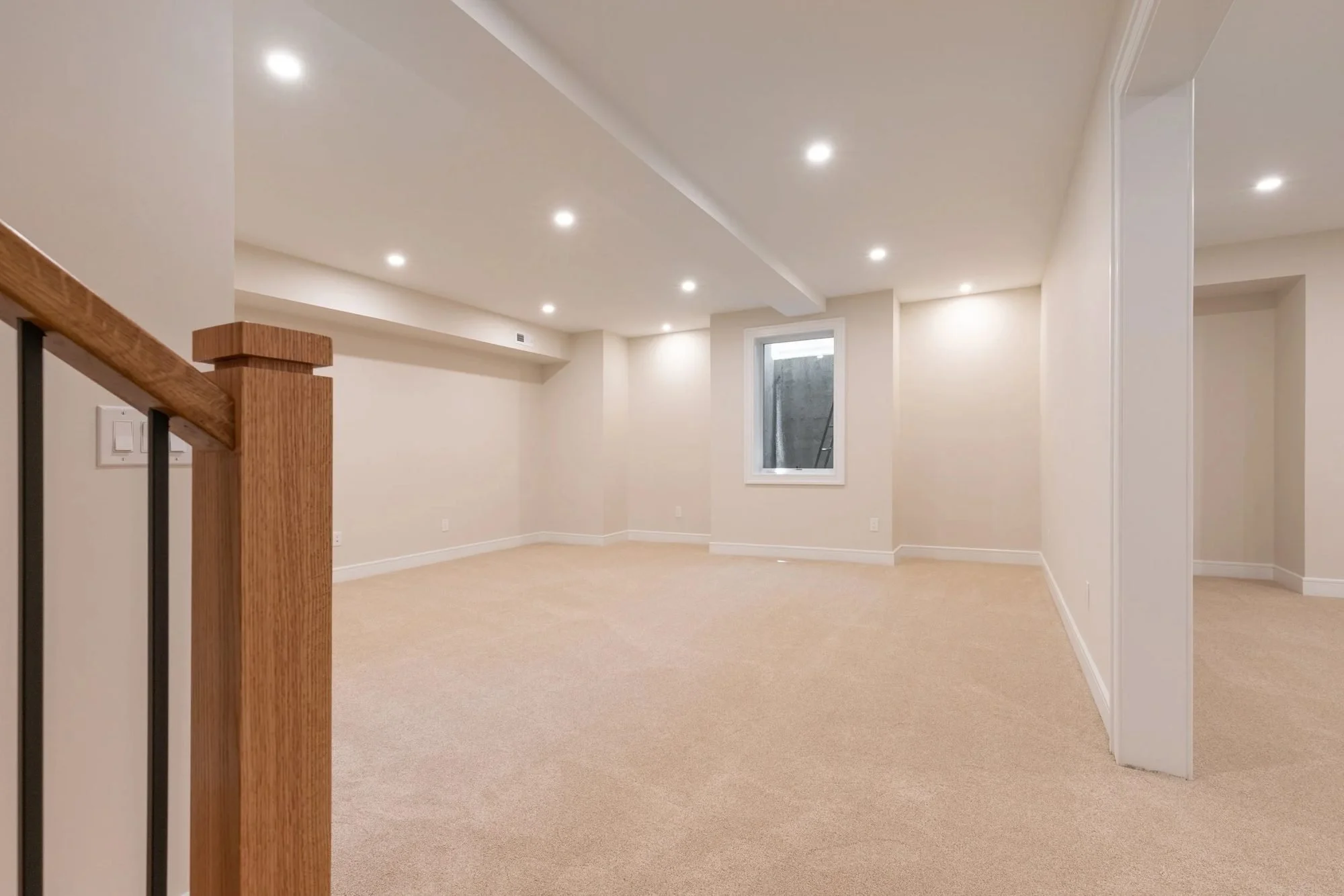 Finished basement with carpet and recessed lighting