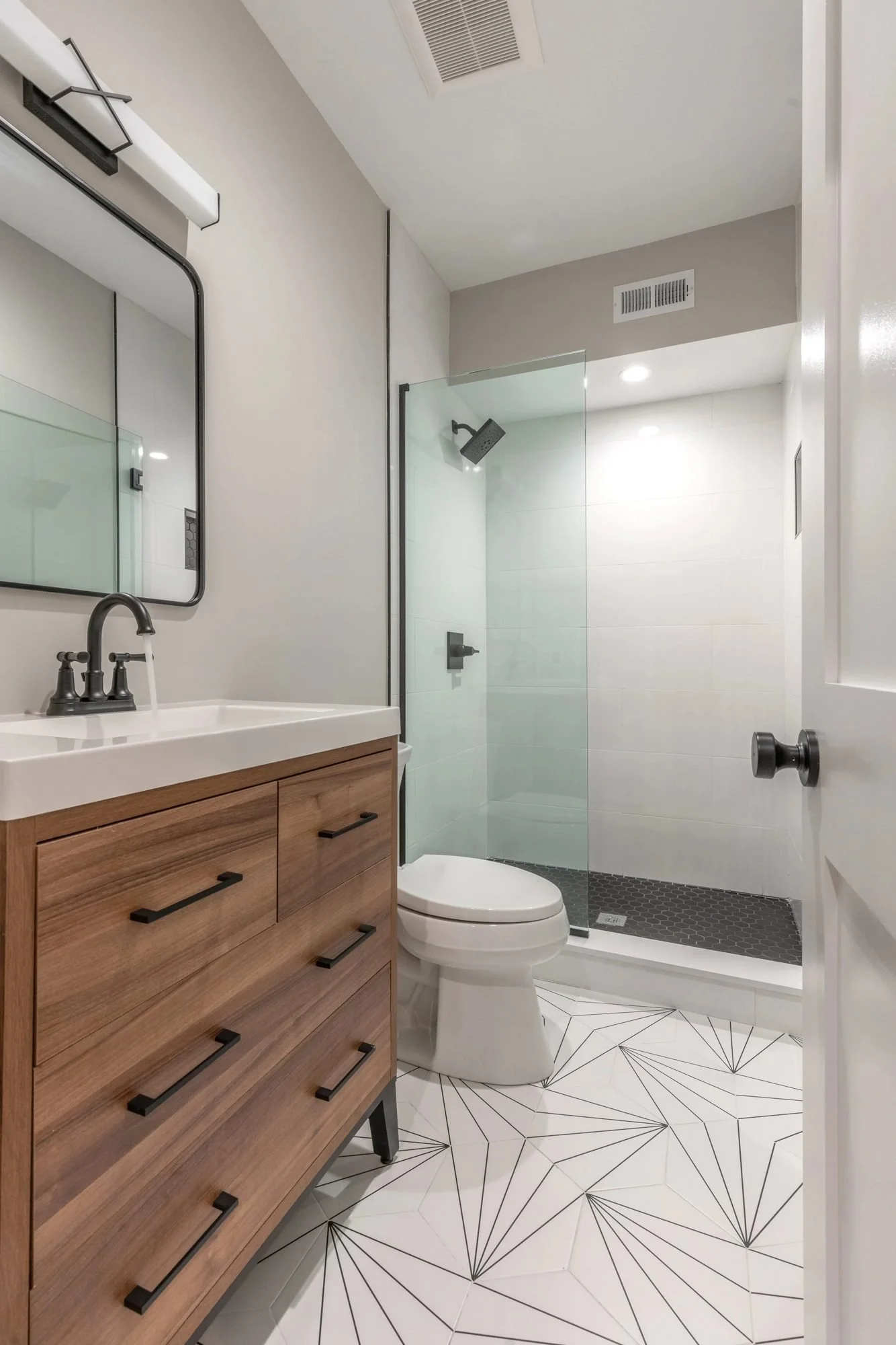 Bathroom with wood vanity and white star-pattern floor tile