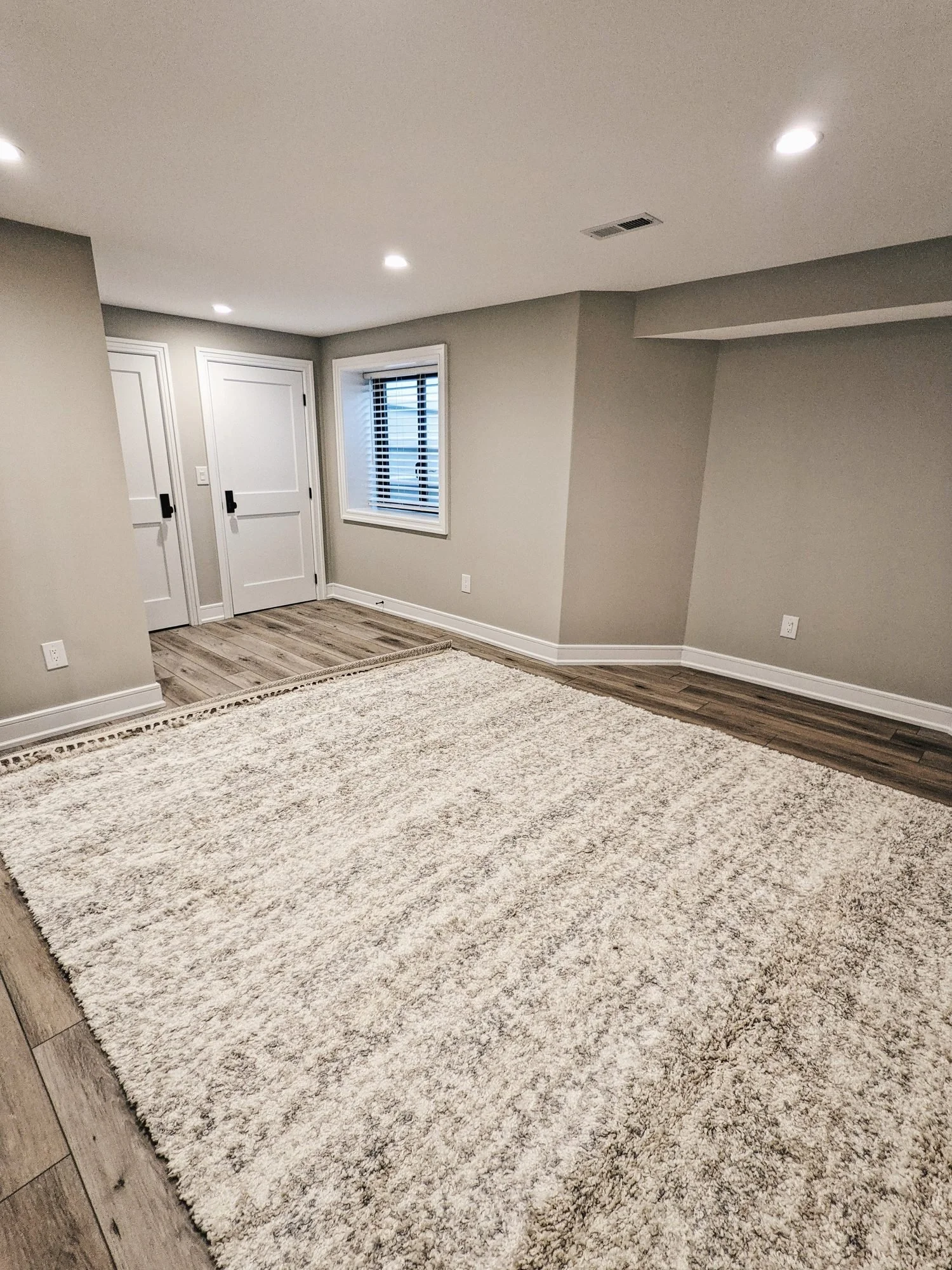 Finished basement guest room with vinyl plank floors