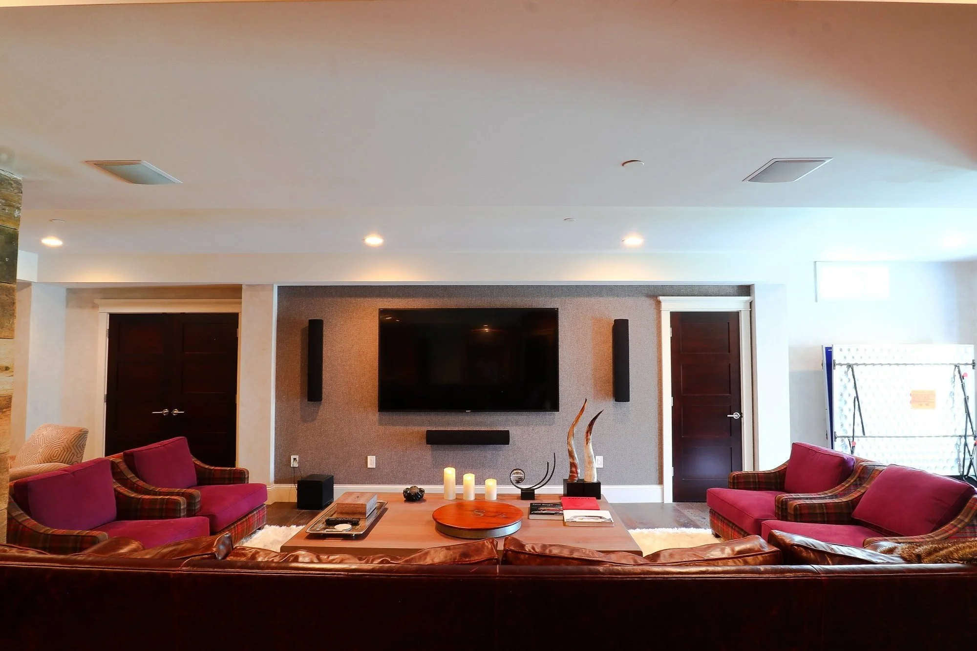 Luxury basement lounge with media wall and accent chairs