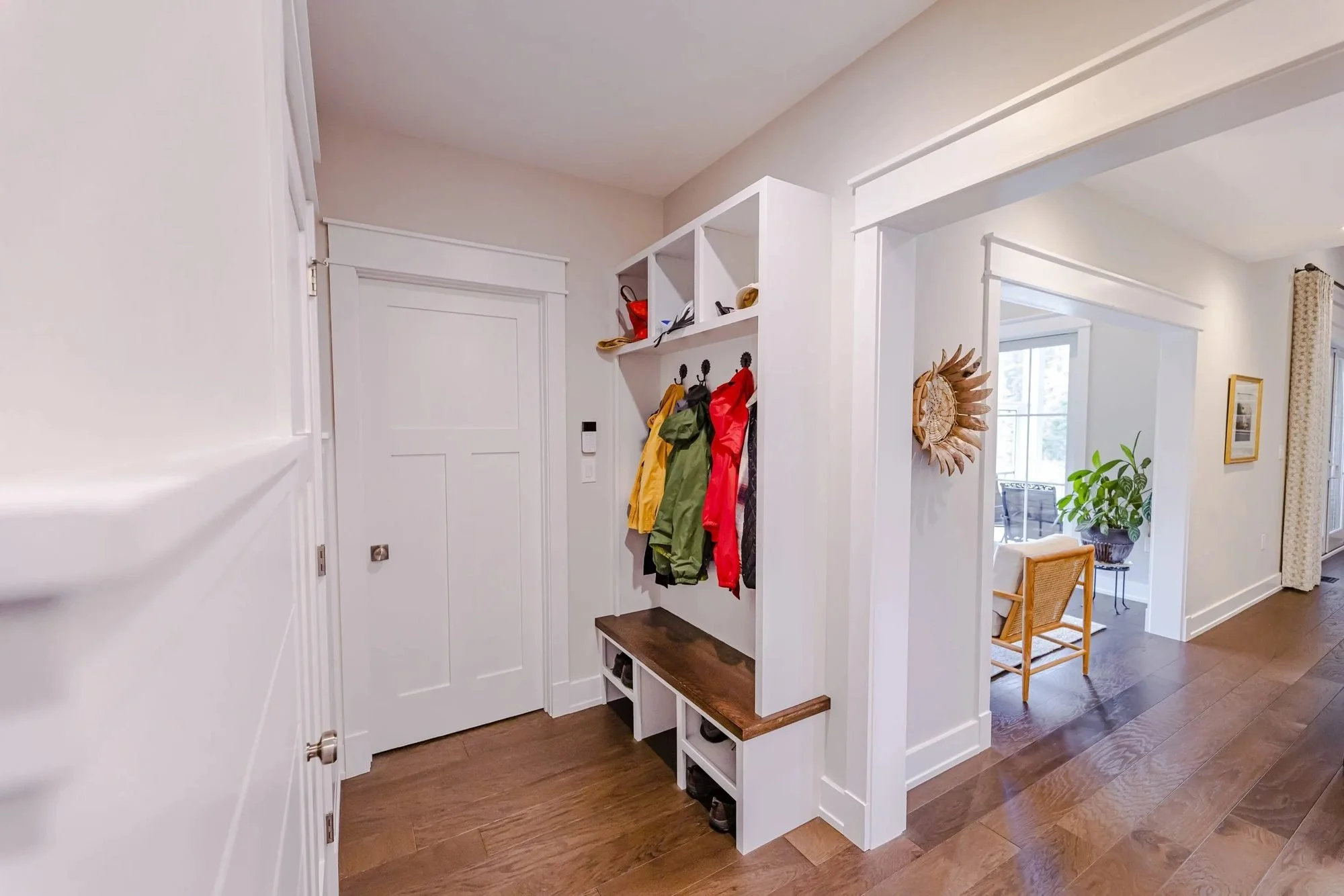 Mudroom with built-in cubbies, bench seat and hardwood floors