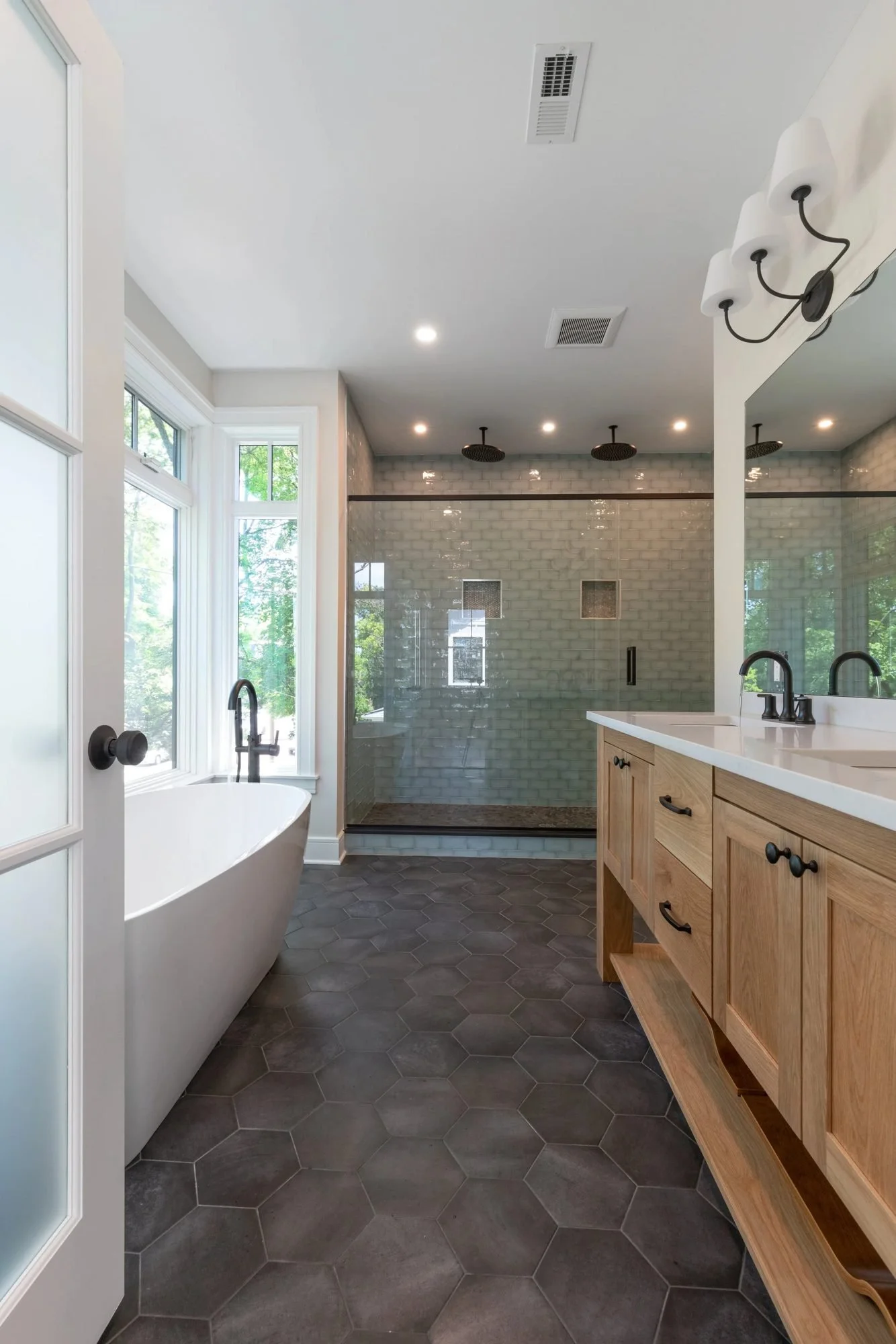 Primary bathroom with soaking tub and glass walk-in shower