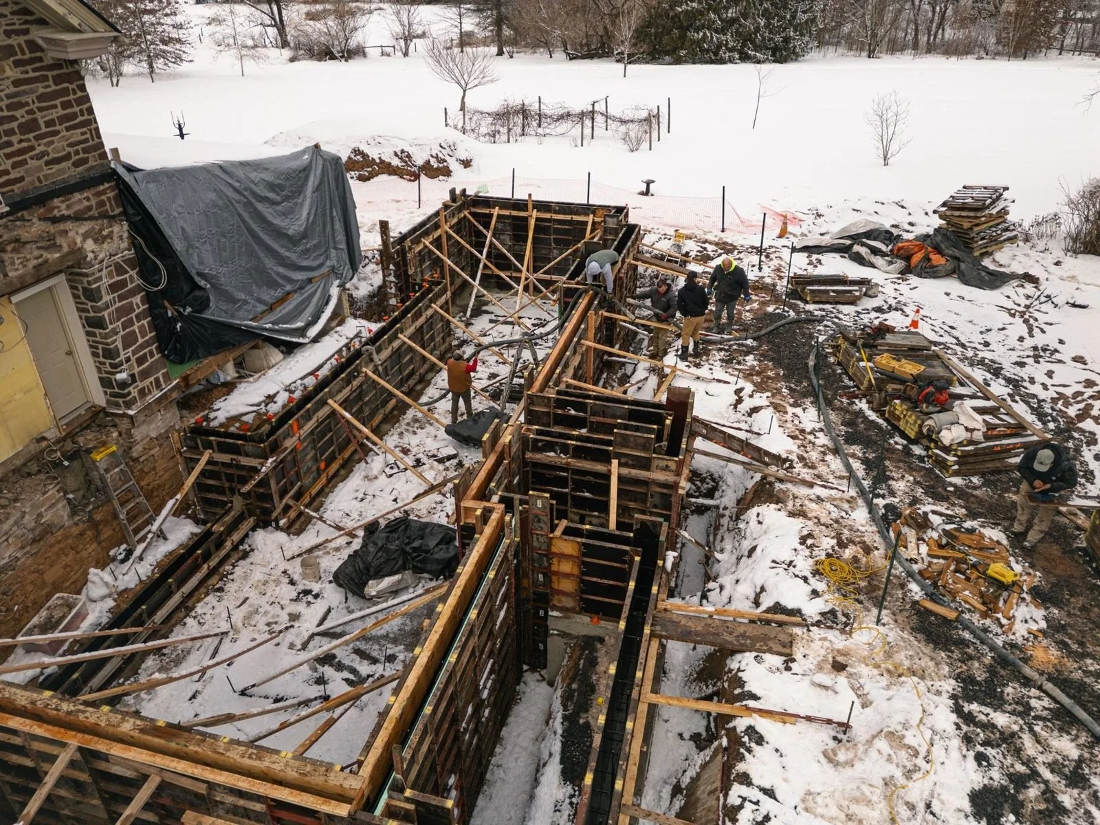Foundation wall forms in the snow for a Bucks County farmhouse addition