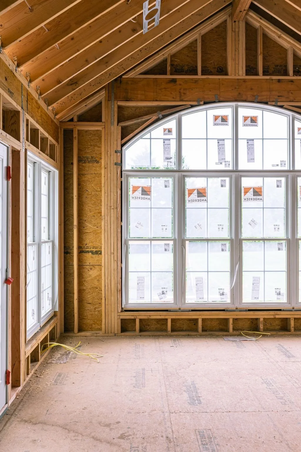Arched window opening framed in a Bucks County farmhouse addition