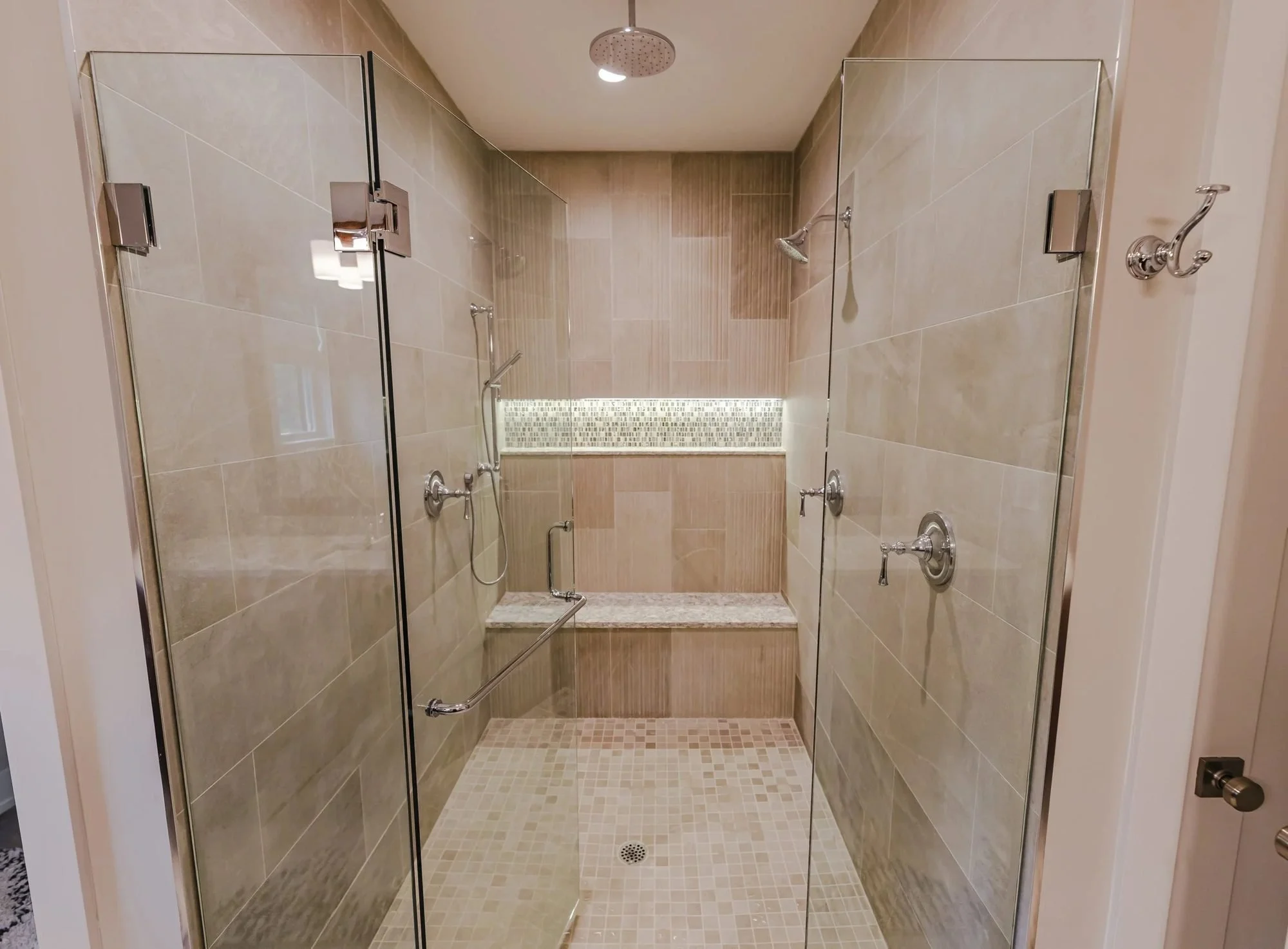 Primary bathroom walk-in shower with frameless glass