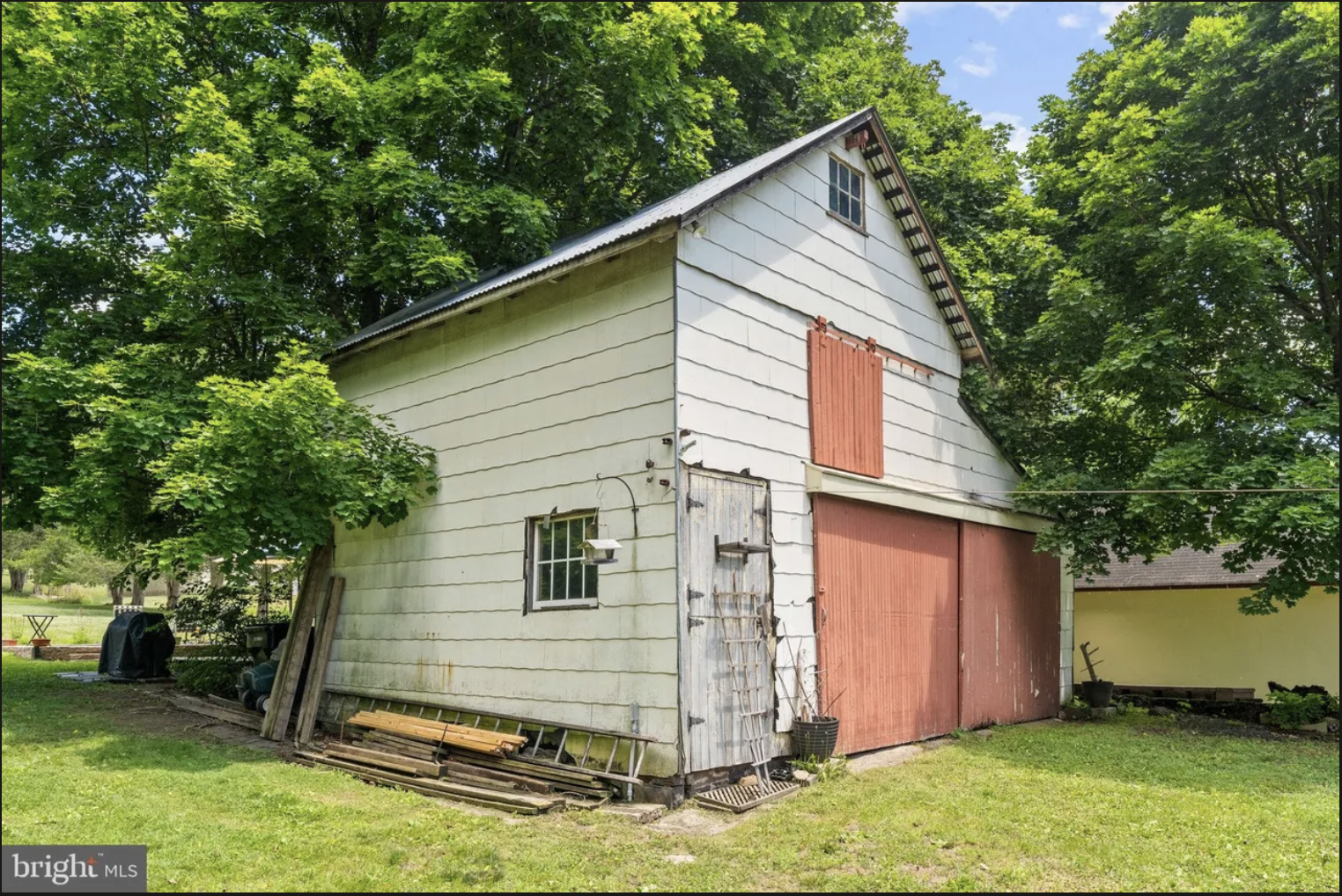 Detached garage and barn at an Ottsville colonial home offering excellent potential for a future guest suite, home office, gym, or flexible living space.