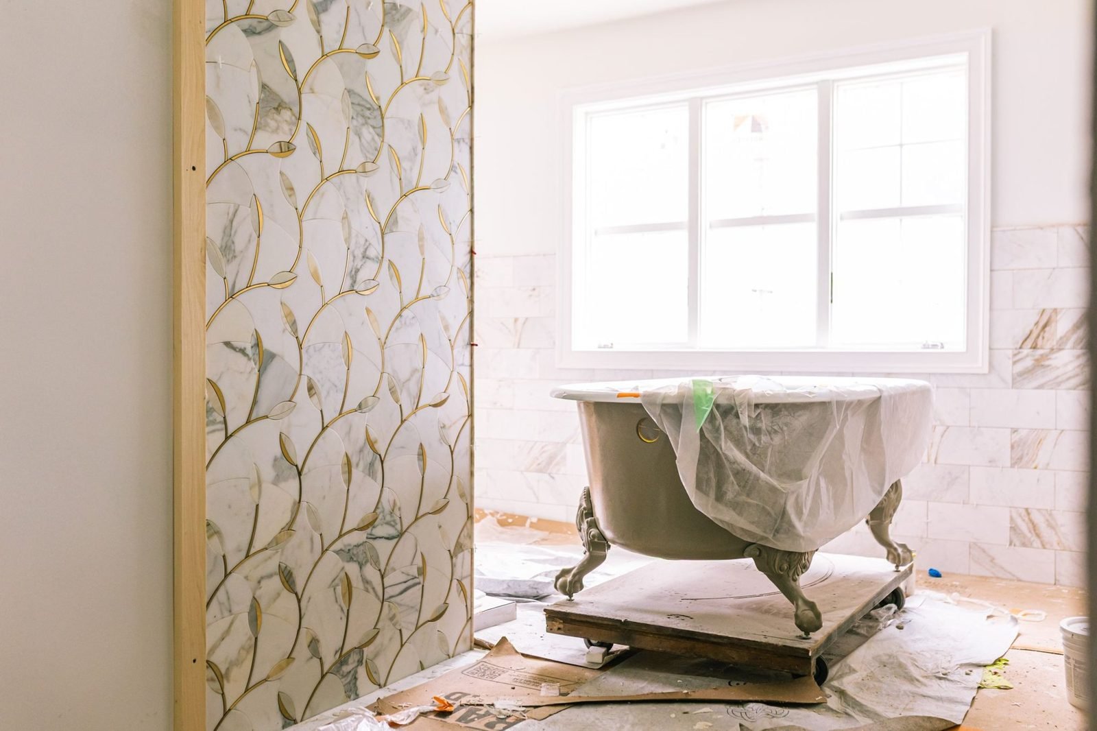 Primary bath with wallpaper and soaking tub in a Bucks County farmhouse