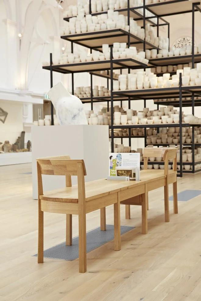 Gallery bench in front large ceramic display